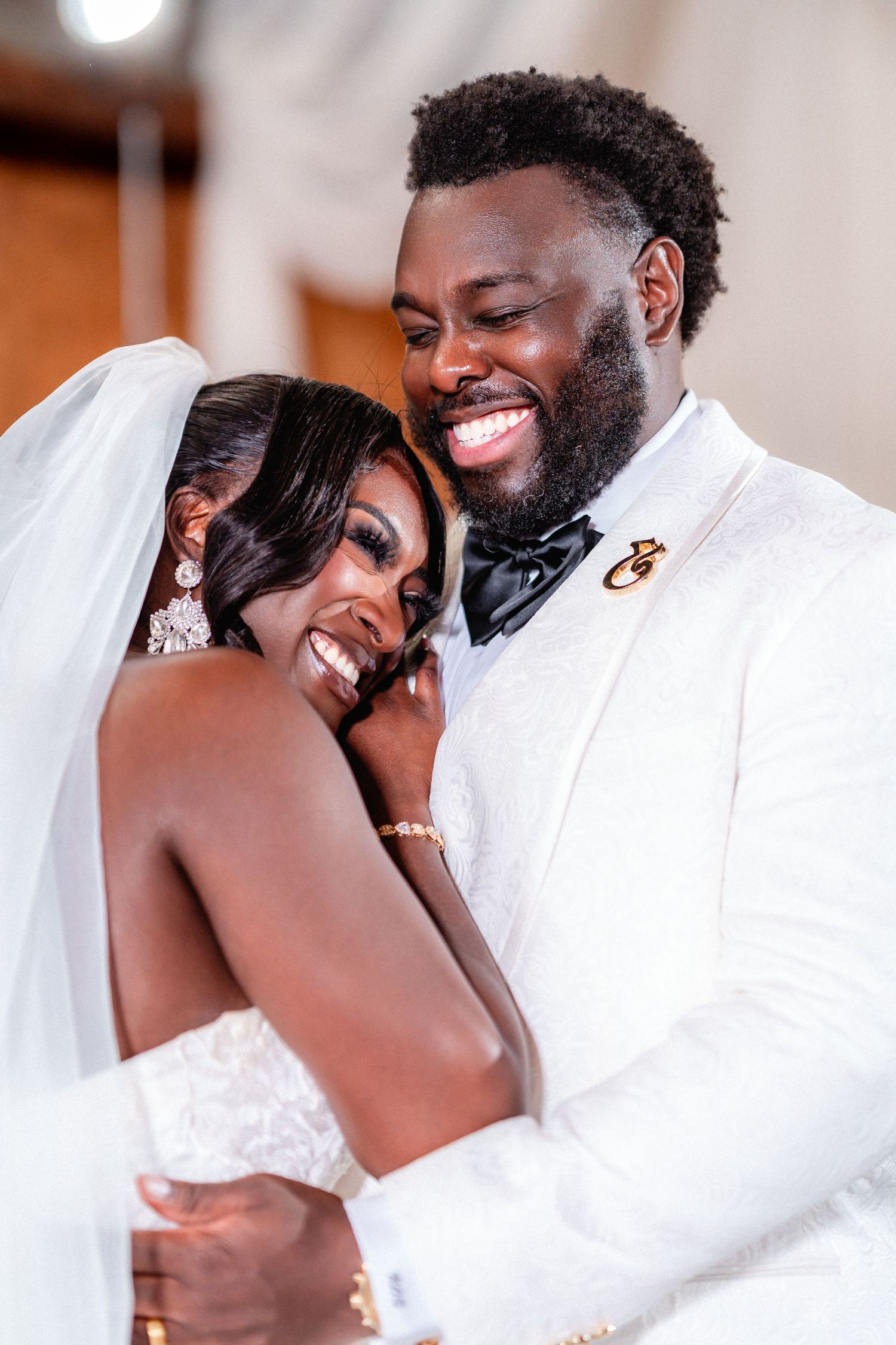 A joyful newlywed couple shares an intimate moment during their wedding celebration.