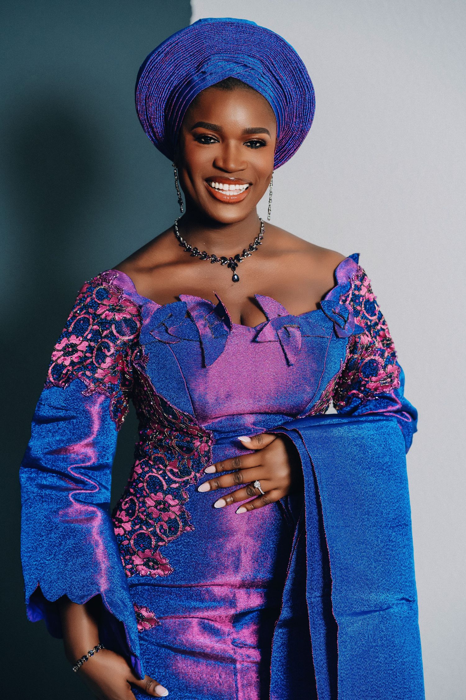 Portrait series showcasing vibrant blue and pink traditional African attire with detailed embellishments and headwrap.