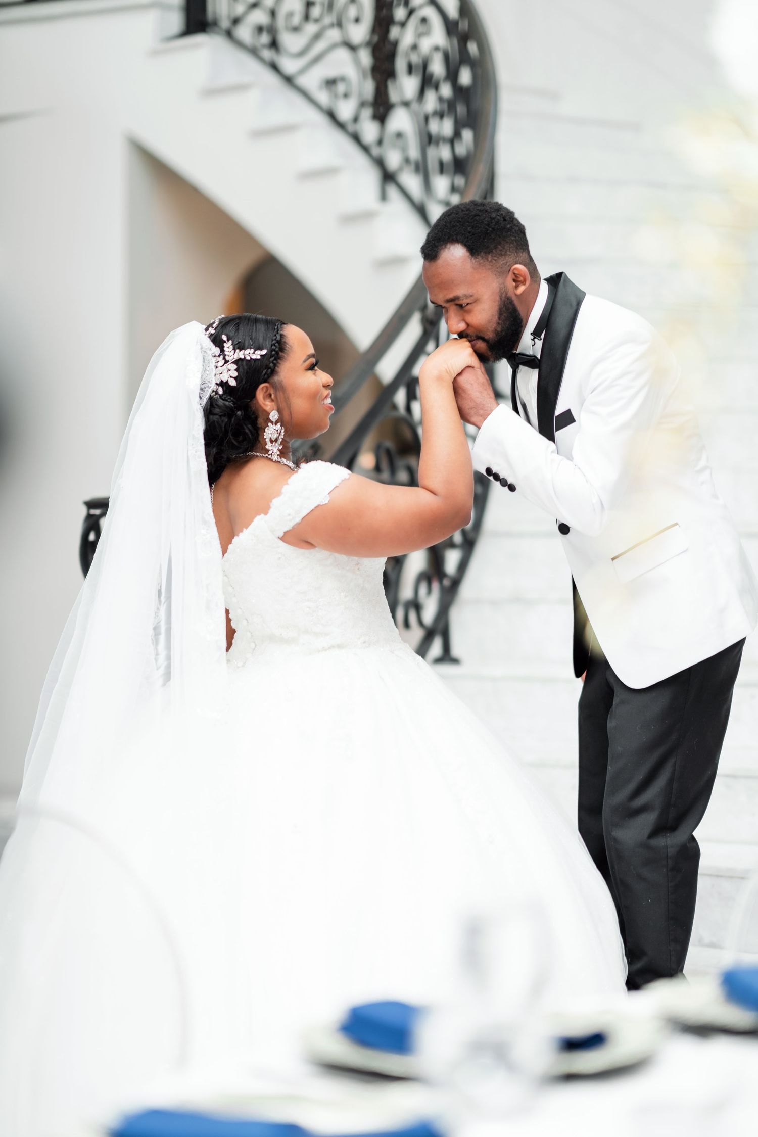 A romantic wedding couple shares intimate moments in a series of elegant white and black formal poses.