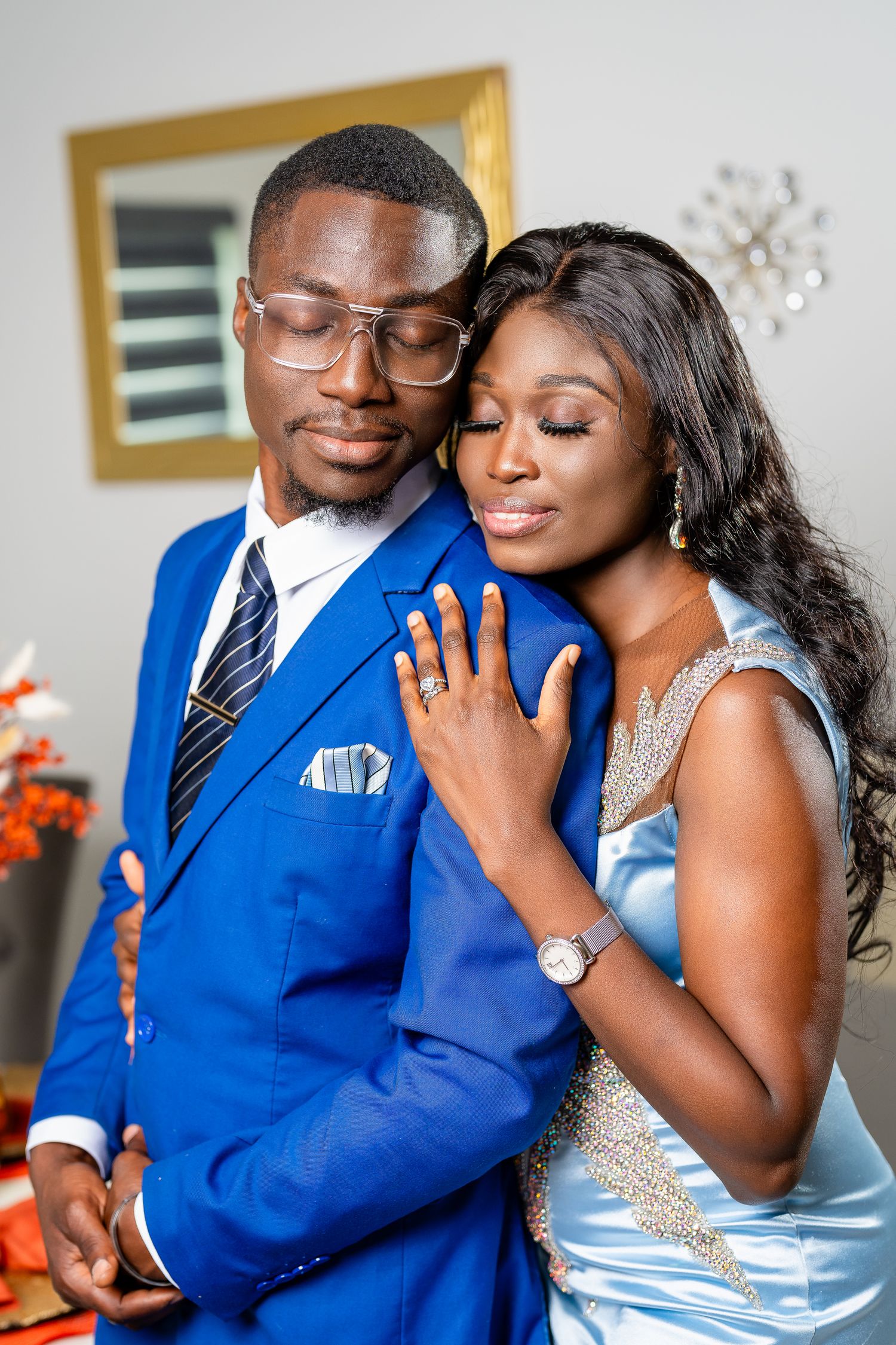 A romantic couple in coordinating blue and silver outfits share intimate moments in a photo collage.