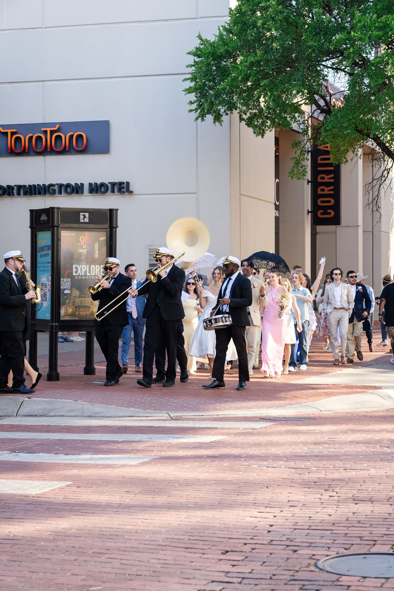 Wedding party and guests gathered outside the Worthington Hotel entrance.