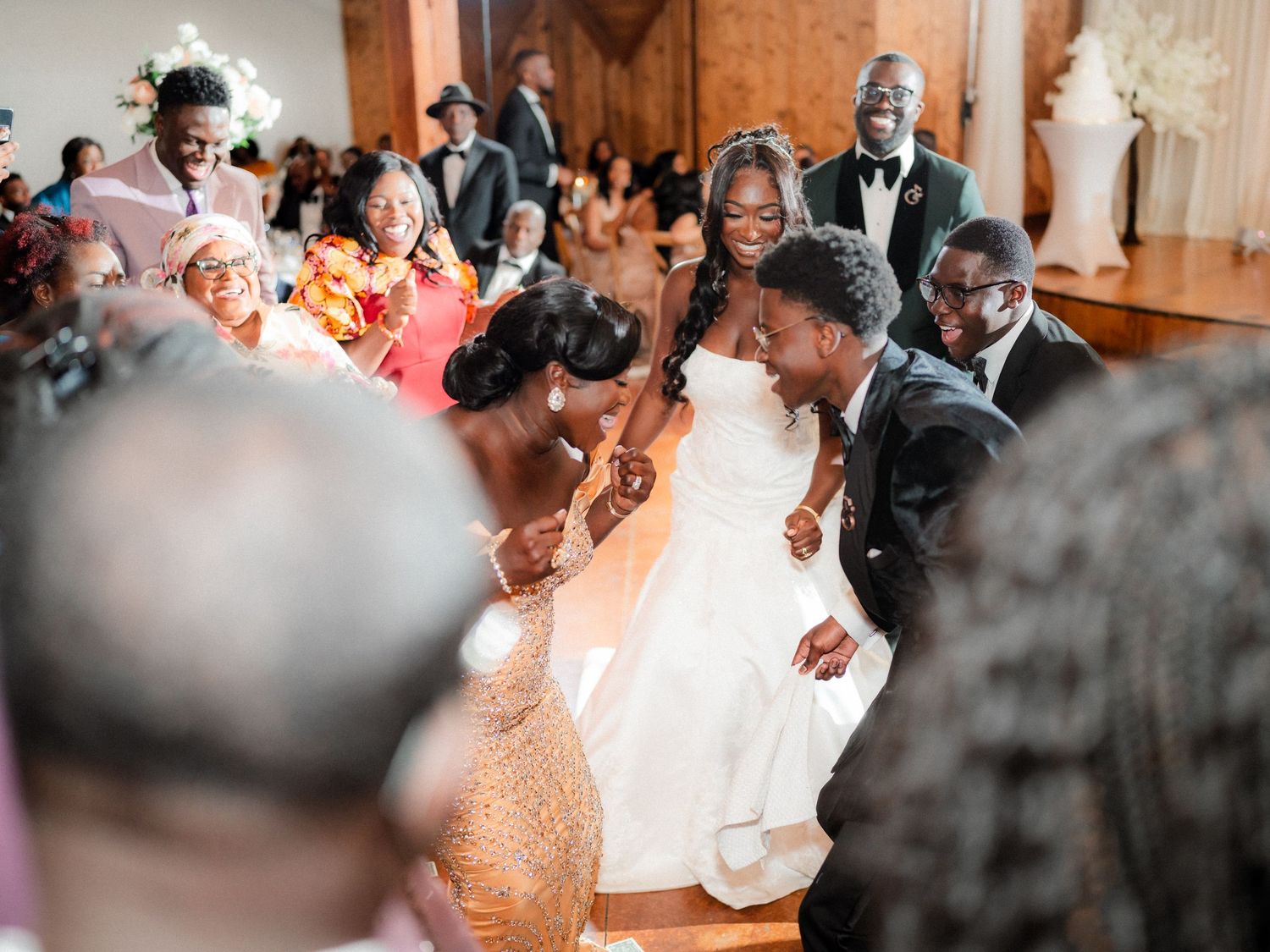 Wedding celebration showing guests dancing and enjoying themselves at an indoor reception venue.