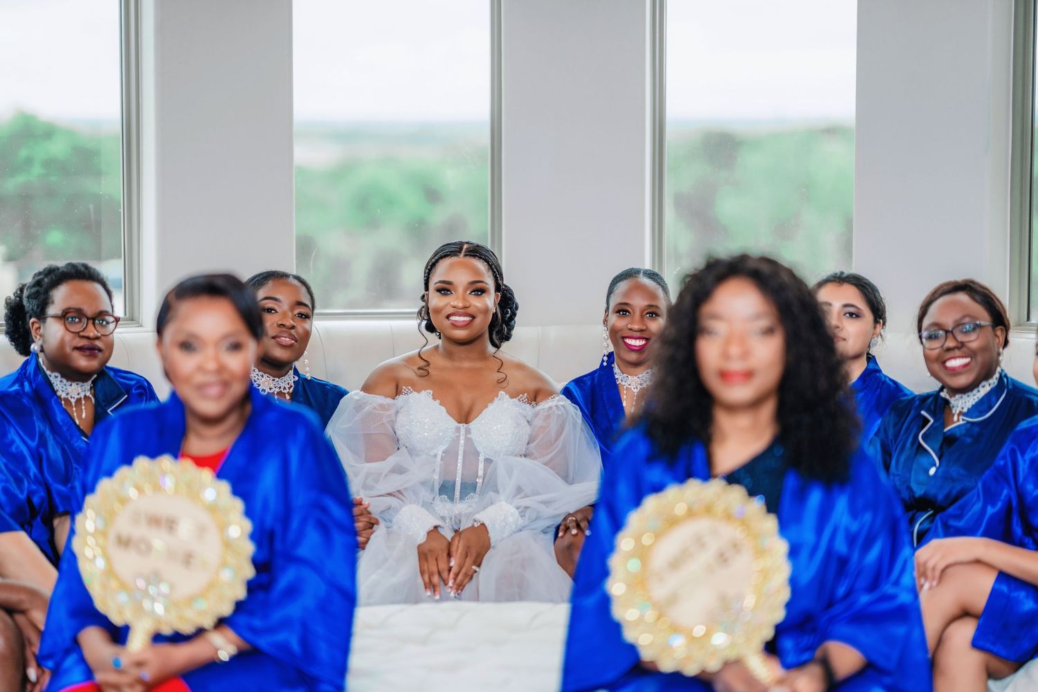 Wedding party members in vibrant blue outfits gathered in celebration.