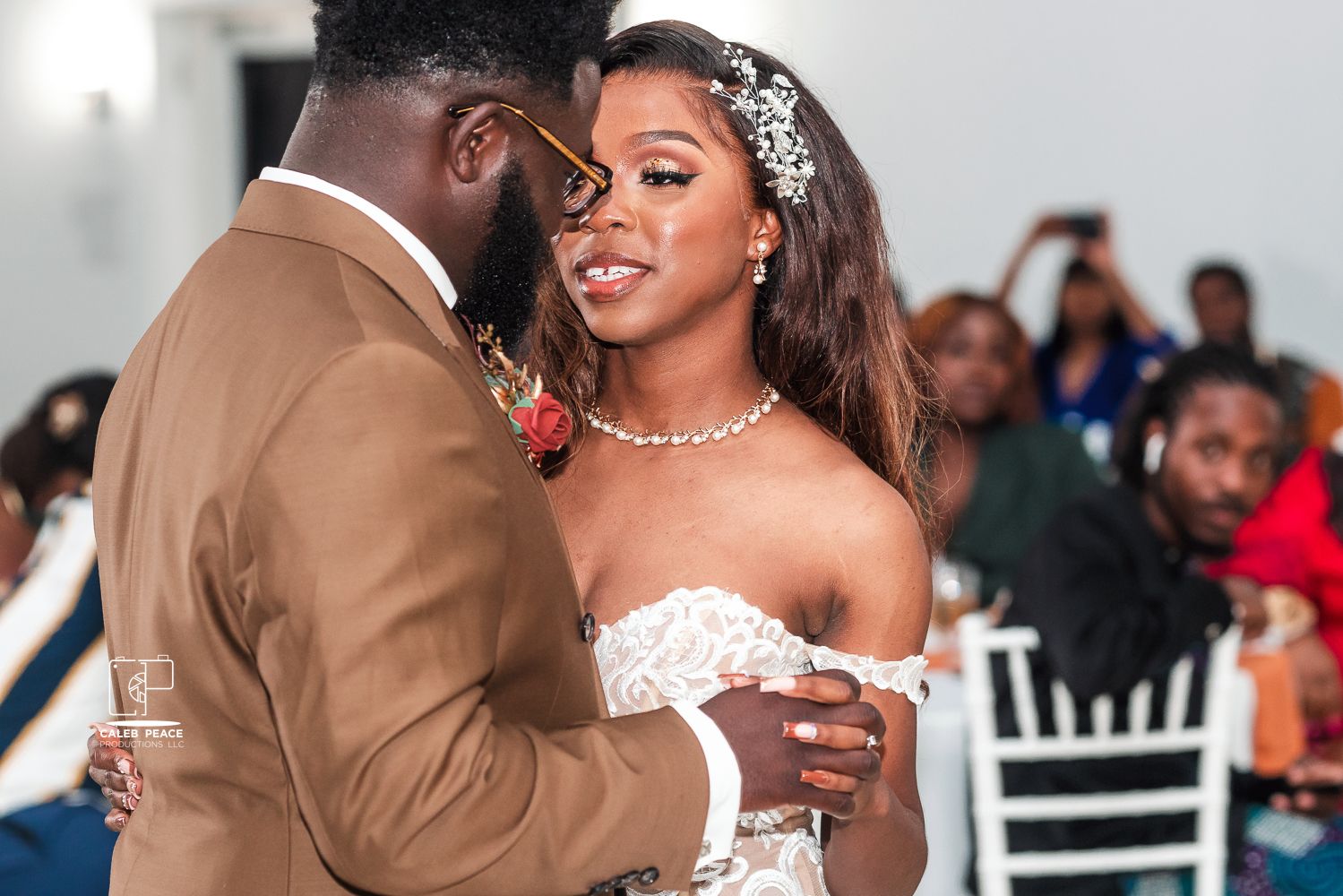 Elegant wedding reception scene with formal attire and white decorative elements.