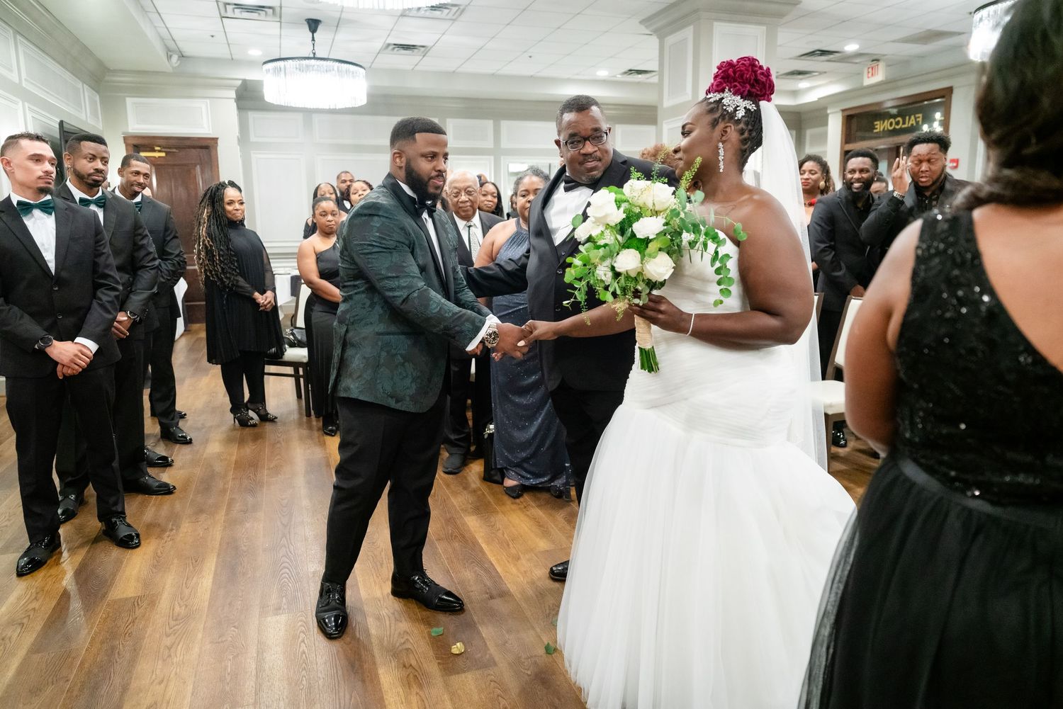 Wedding reception celebration in elegant indoor venue with hardwood floors.