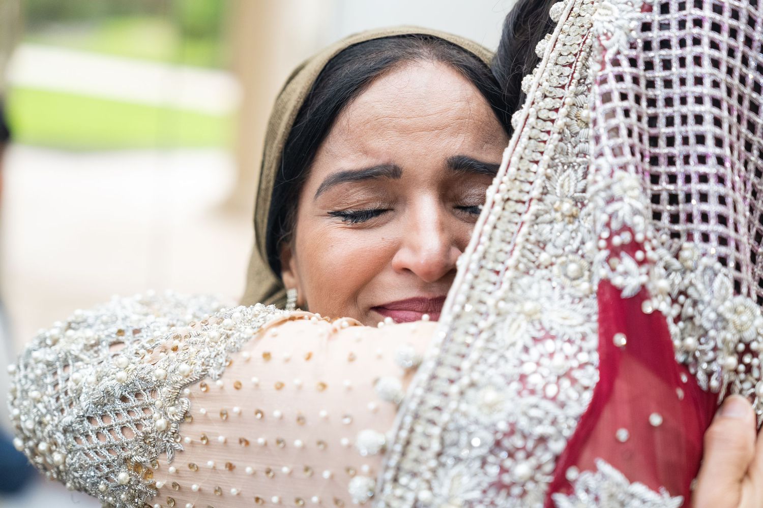 Close-up view of intricate bridal jewelry and veil details.