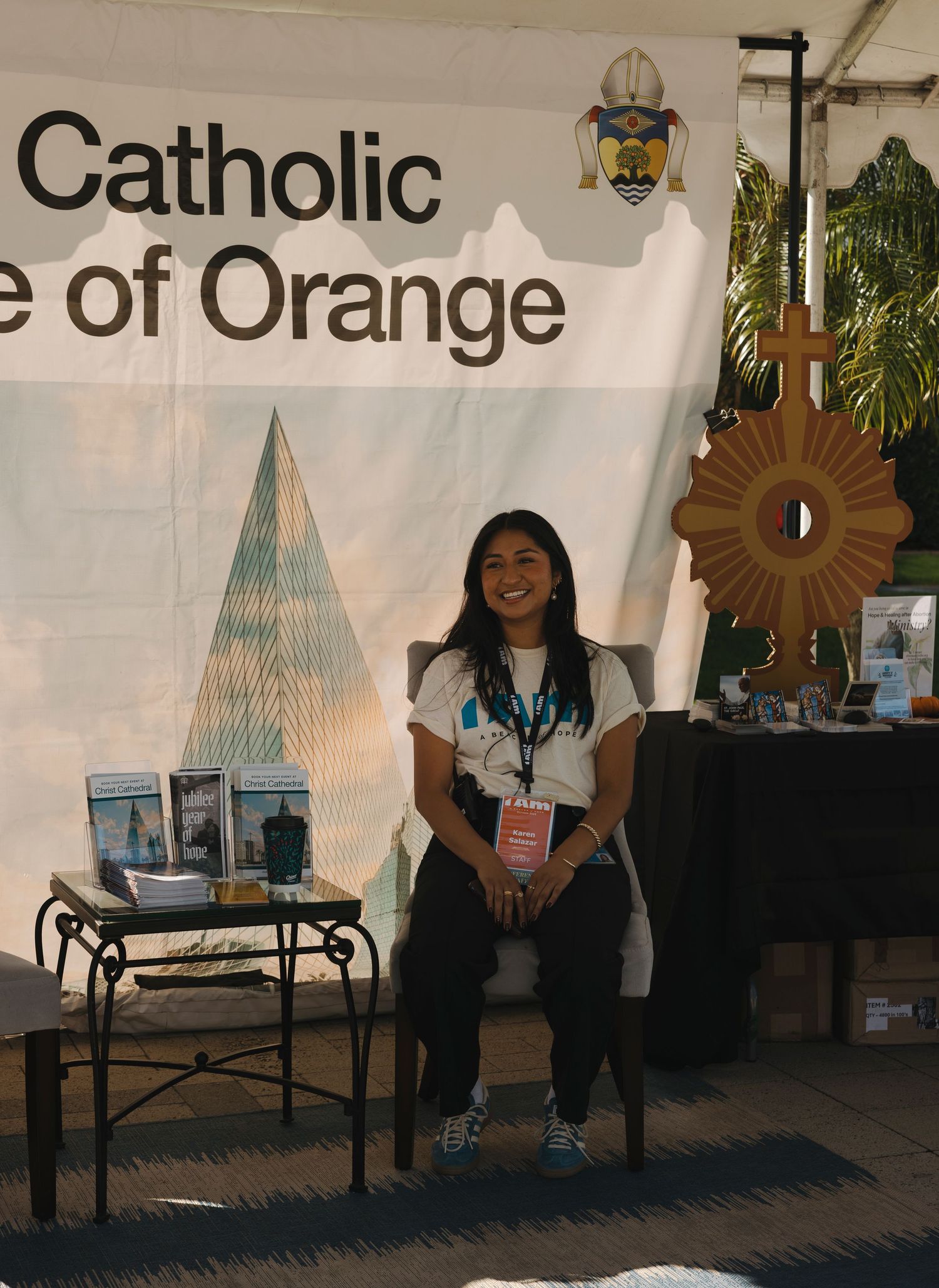 Catholic Diocese of Orange booth setup with informational materials and decorative elements.