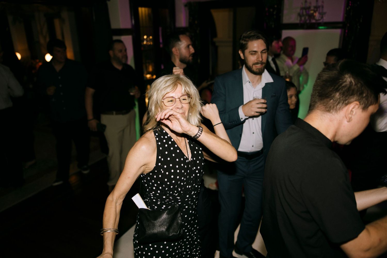 Party guests dancing and enjoying themselves at a nighttime celebration.