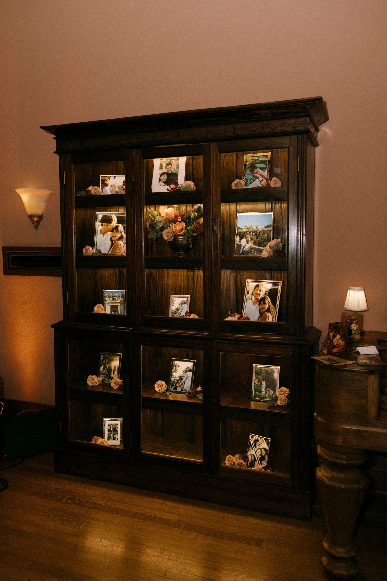 Dark wooden display cabinets with glass doors in an elegant room setting.