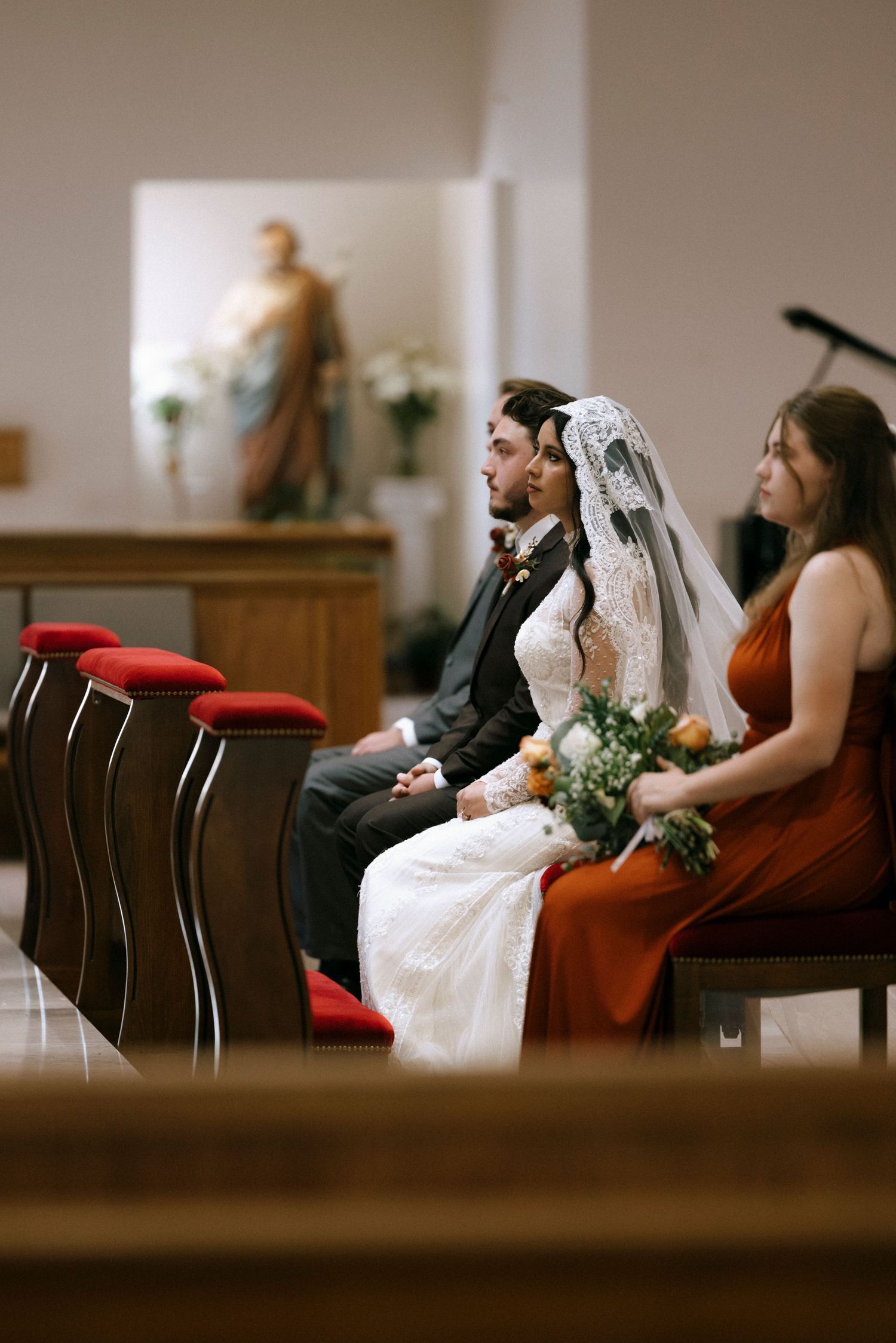 Wedding guests seated in church pews during a ceremony.