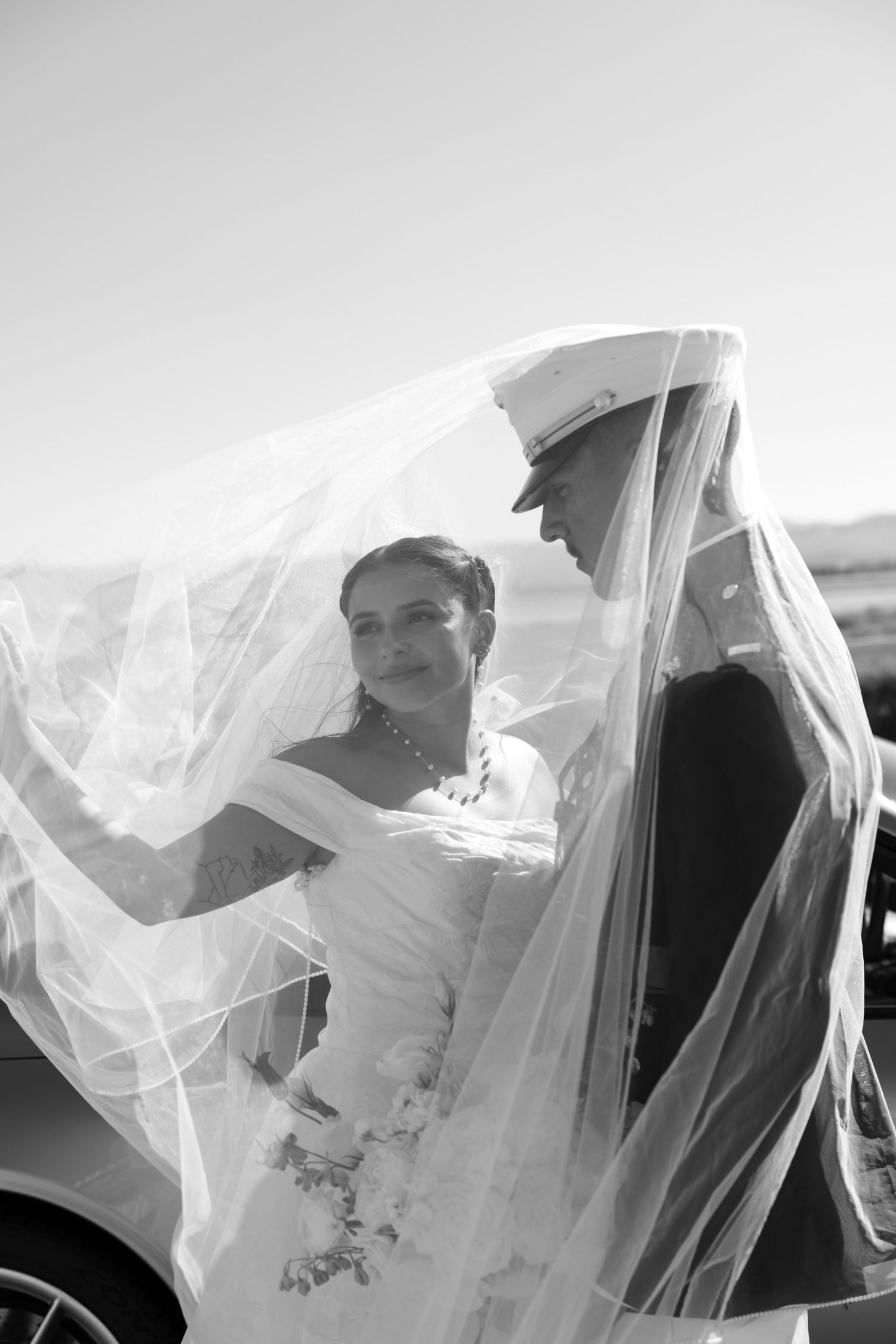Artistic wedding photography sequence showing couple beneath flowing white veil.
