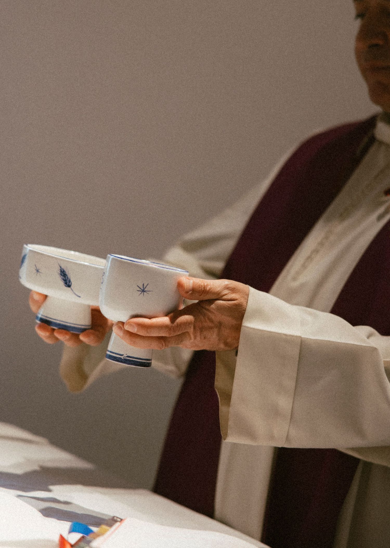 Close-up of hands holding white paper during ceremony.