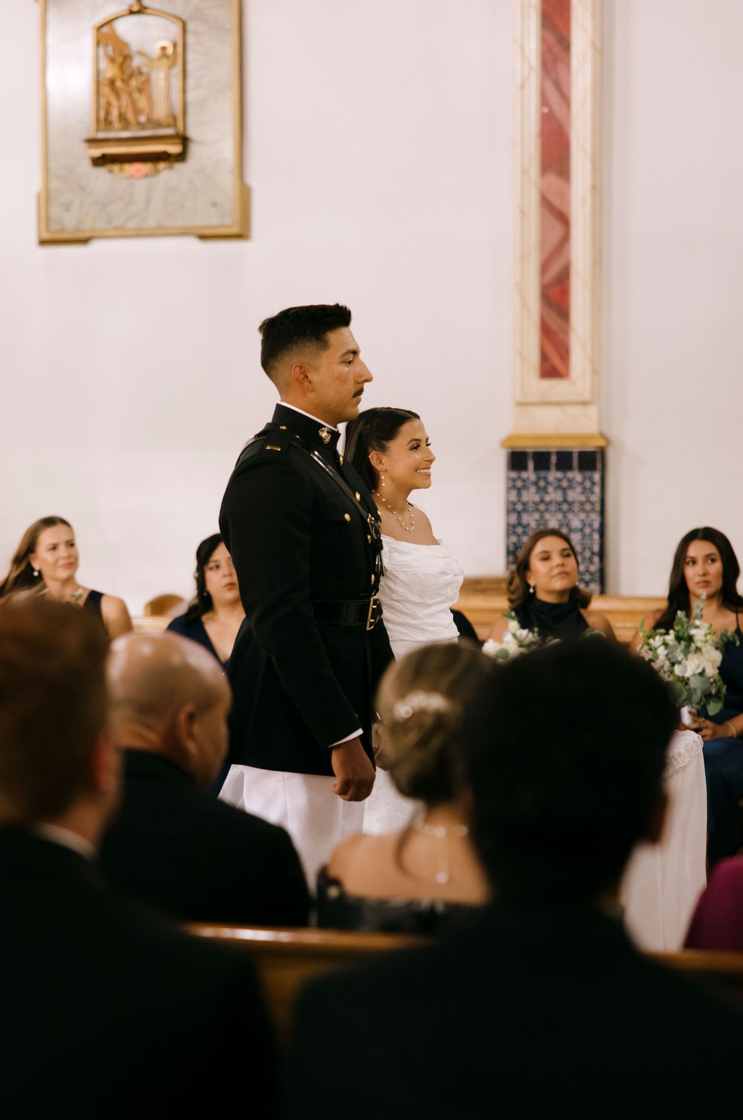 A couple stands at the altar during their wedding ceremony in a church.