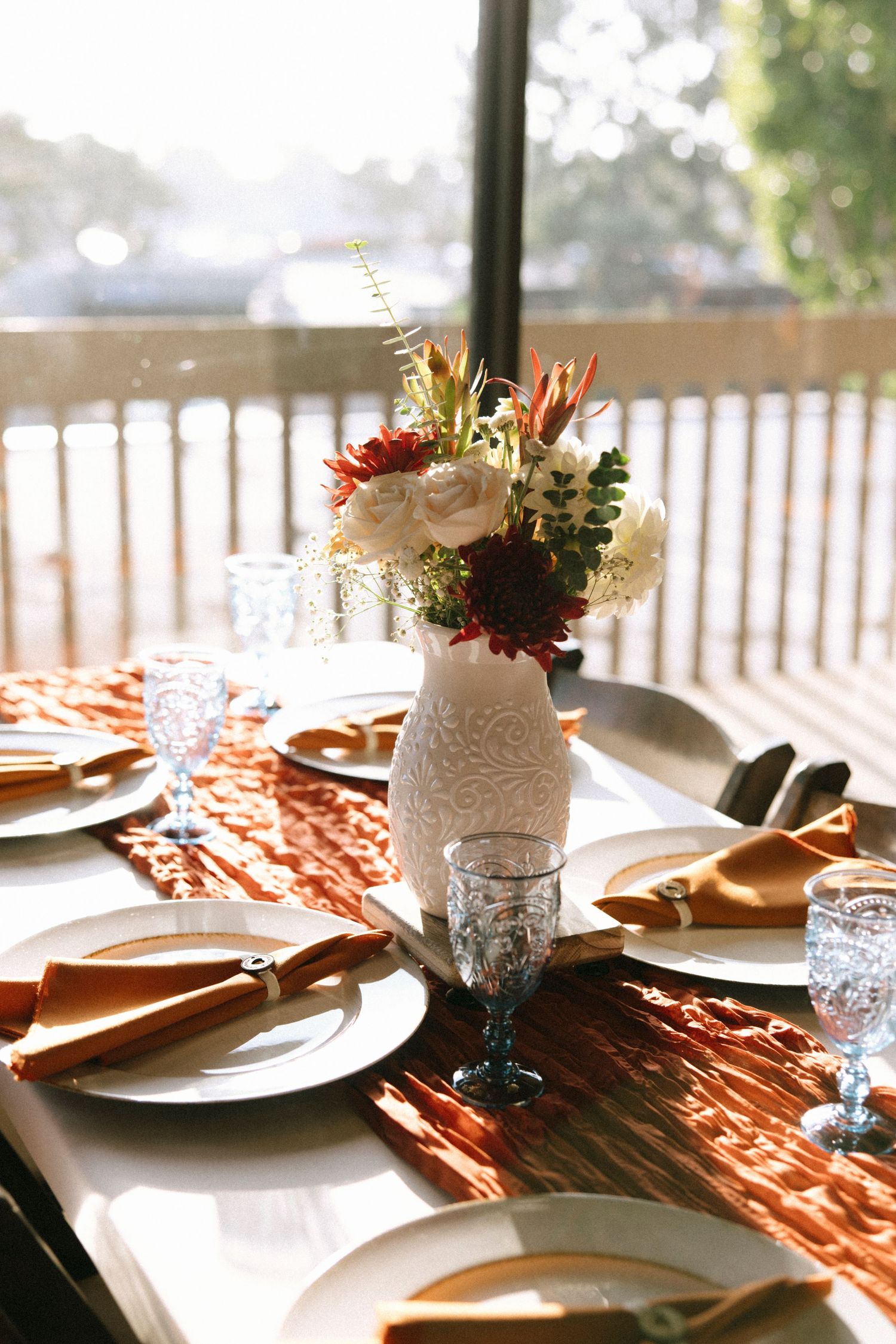 Elegant wedding table setting with rustic details and floral centerpieces.