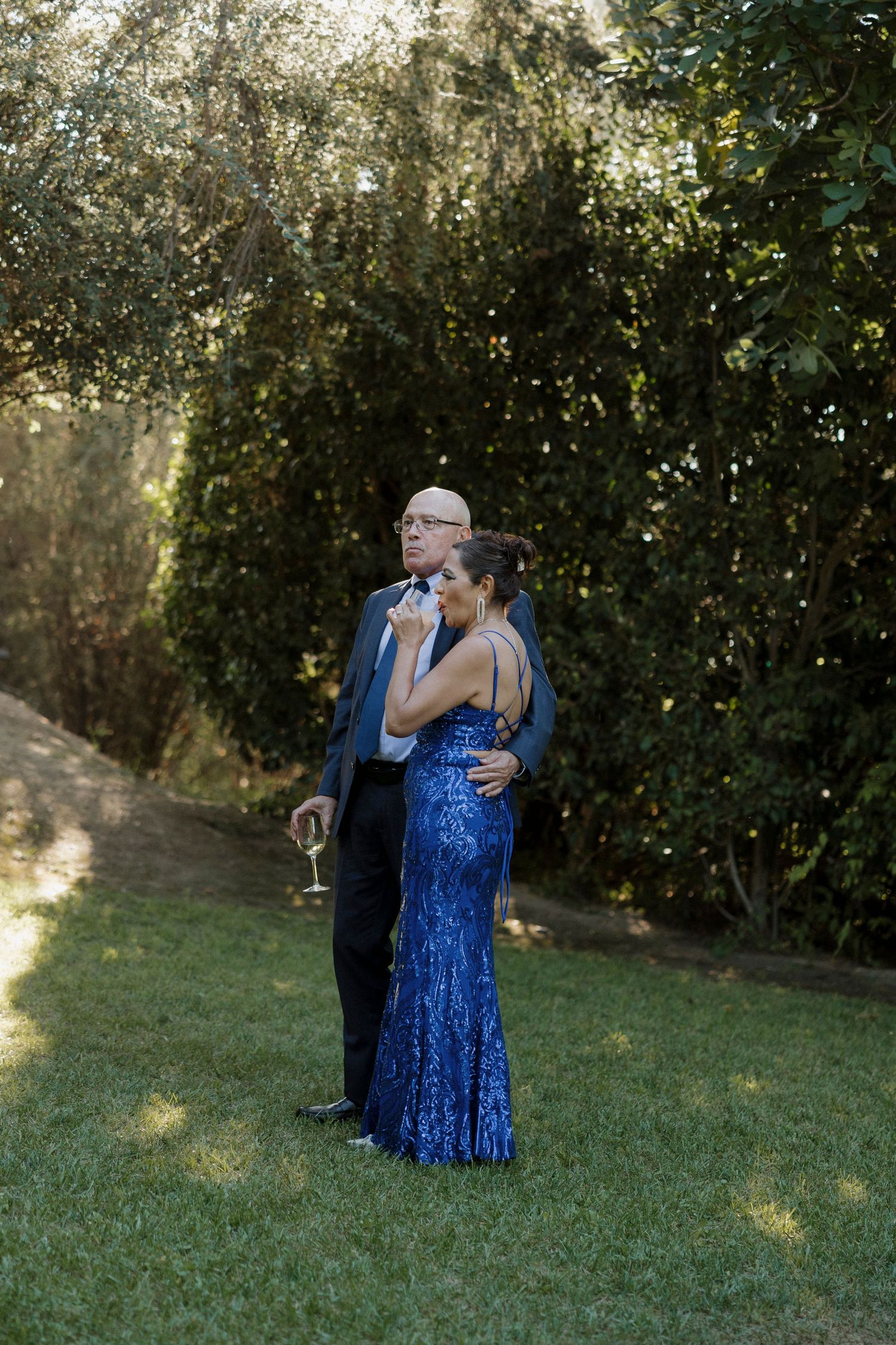Wedding celebration candid moments captured in an outdoor garden setting.