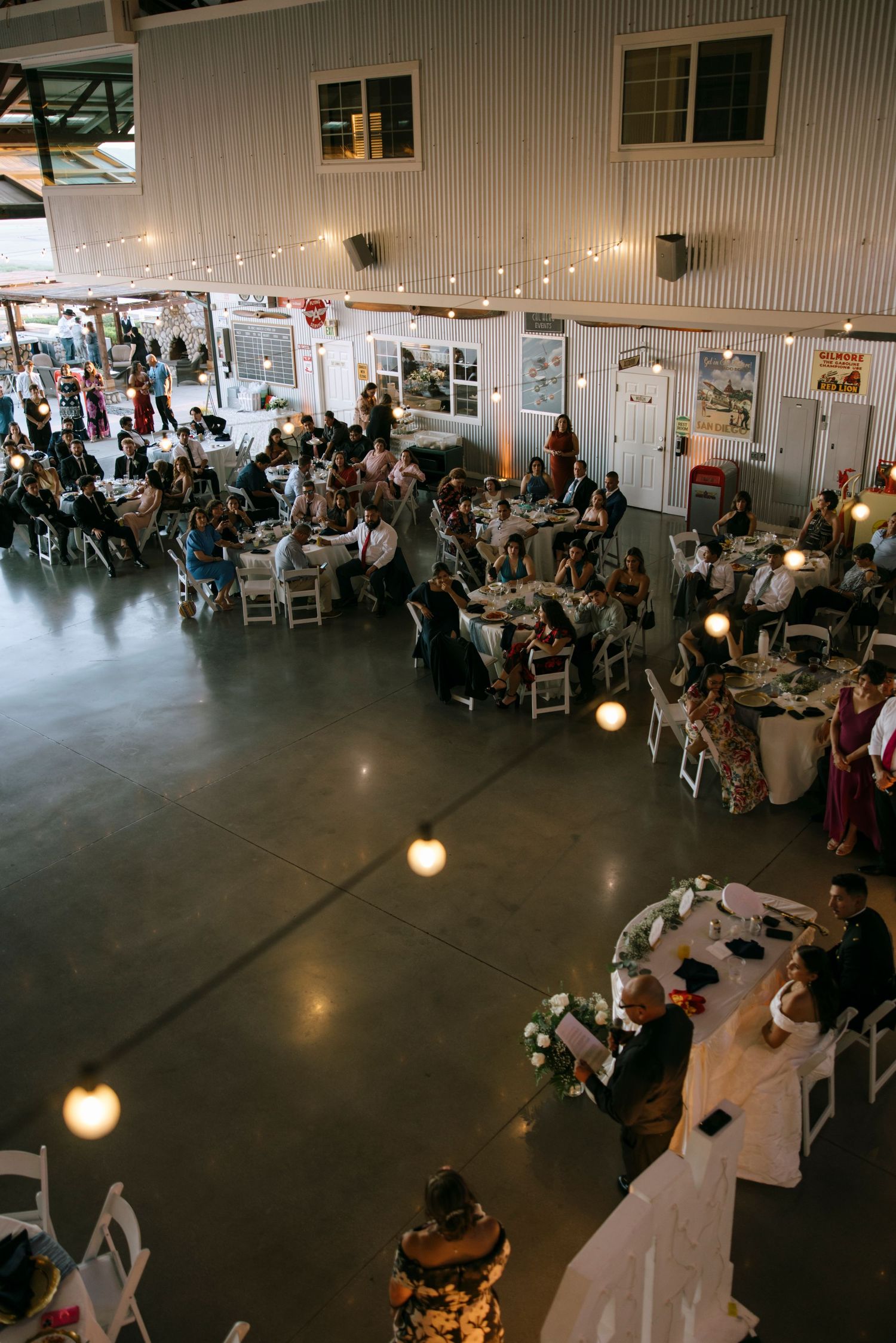 Wedding reception hall filled with guests and ambient lighting.