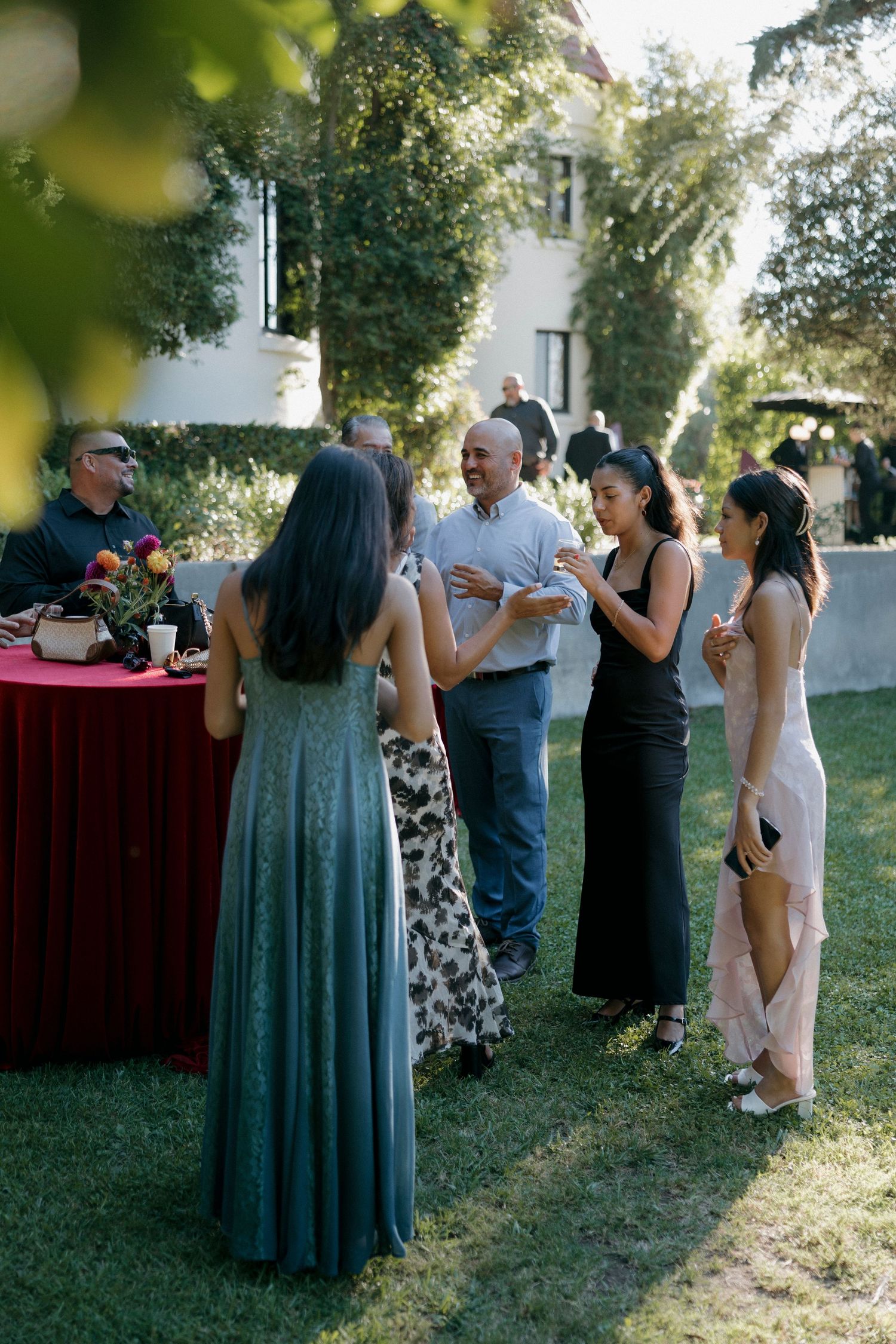 Wedding guests mingle and socialize during an outdoor cocktail reception.