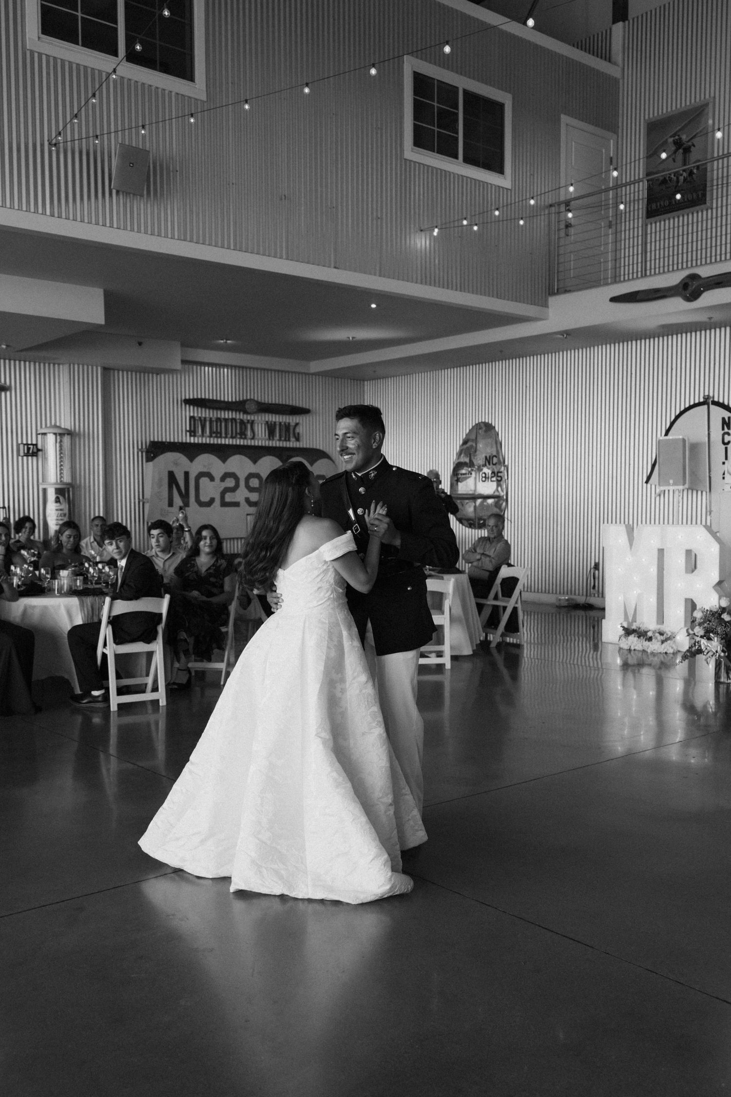 Wedding celebration features choreographed dance sequence in bright indoor venue.