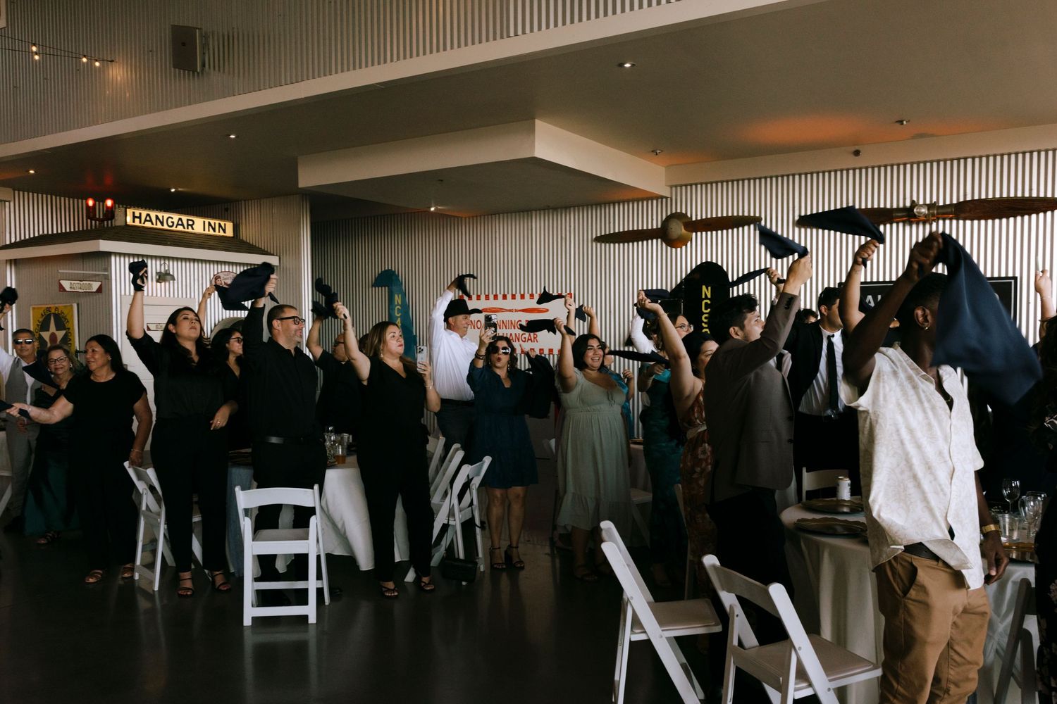 Wedding celebration candid moments captured inside a decorated reception venue.