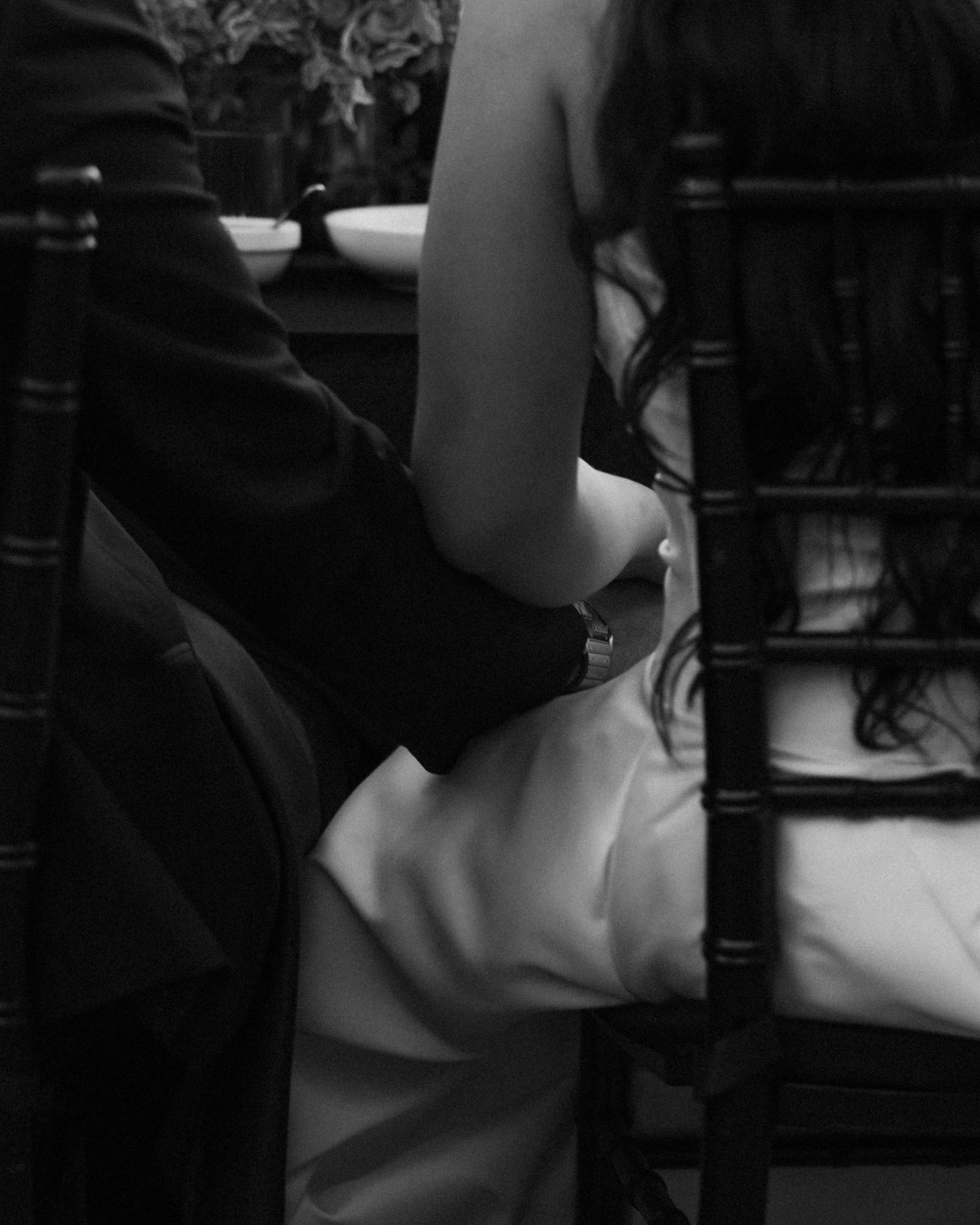 An artistic black and white close-up of a couple embracing during a wedding celebration.