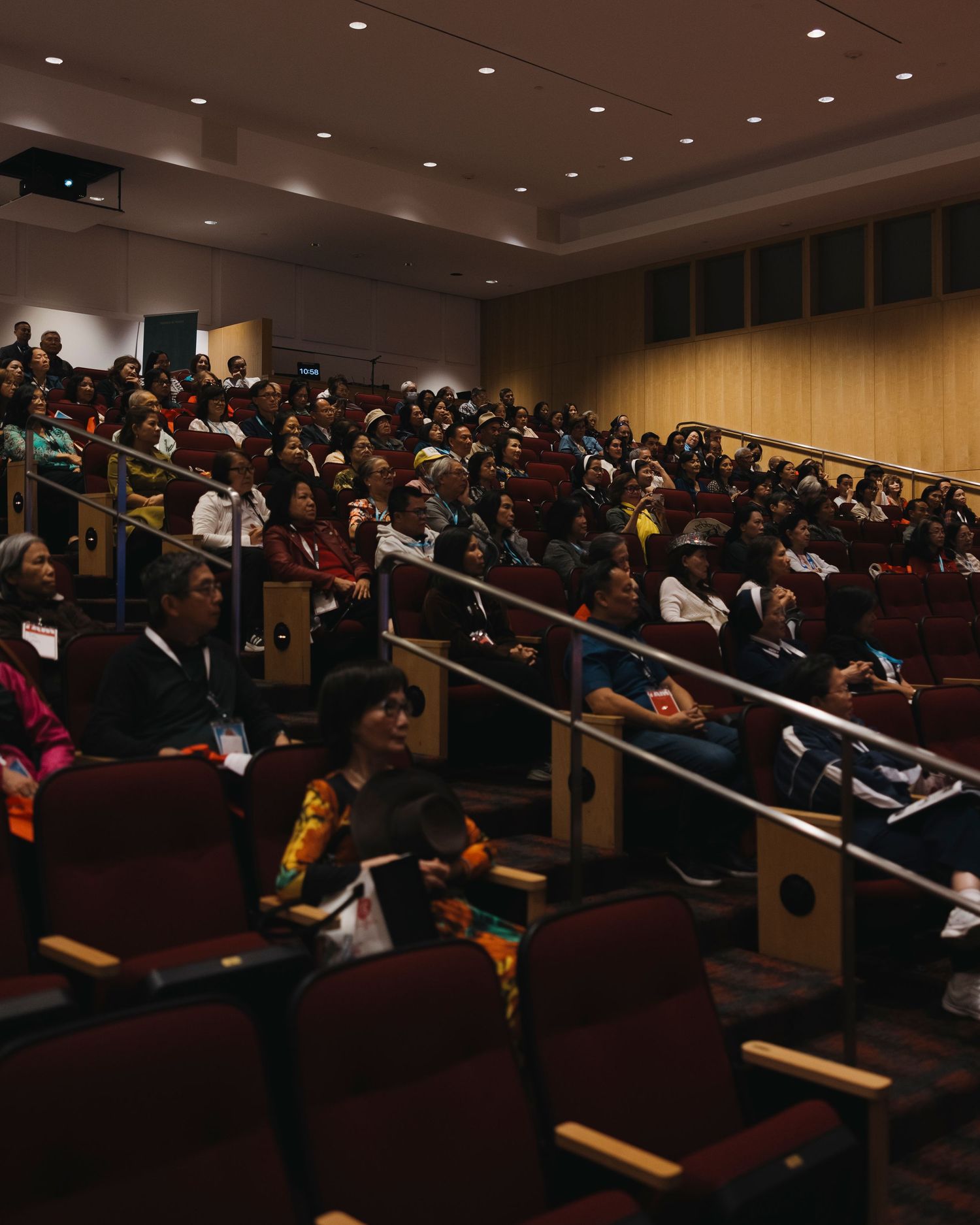 A packed auditorium filled with attendees during a conference or presentation.