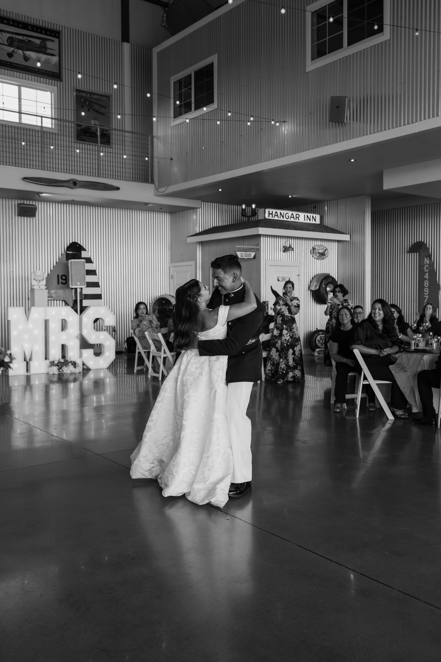 Wide angle shot of wedding party performing coordinated dance routine.