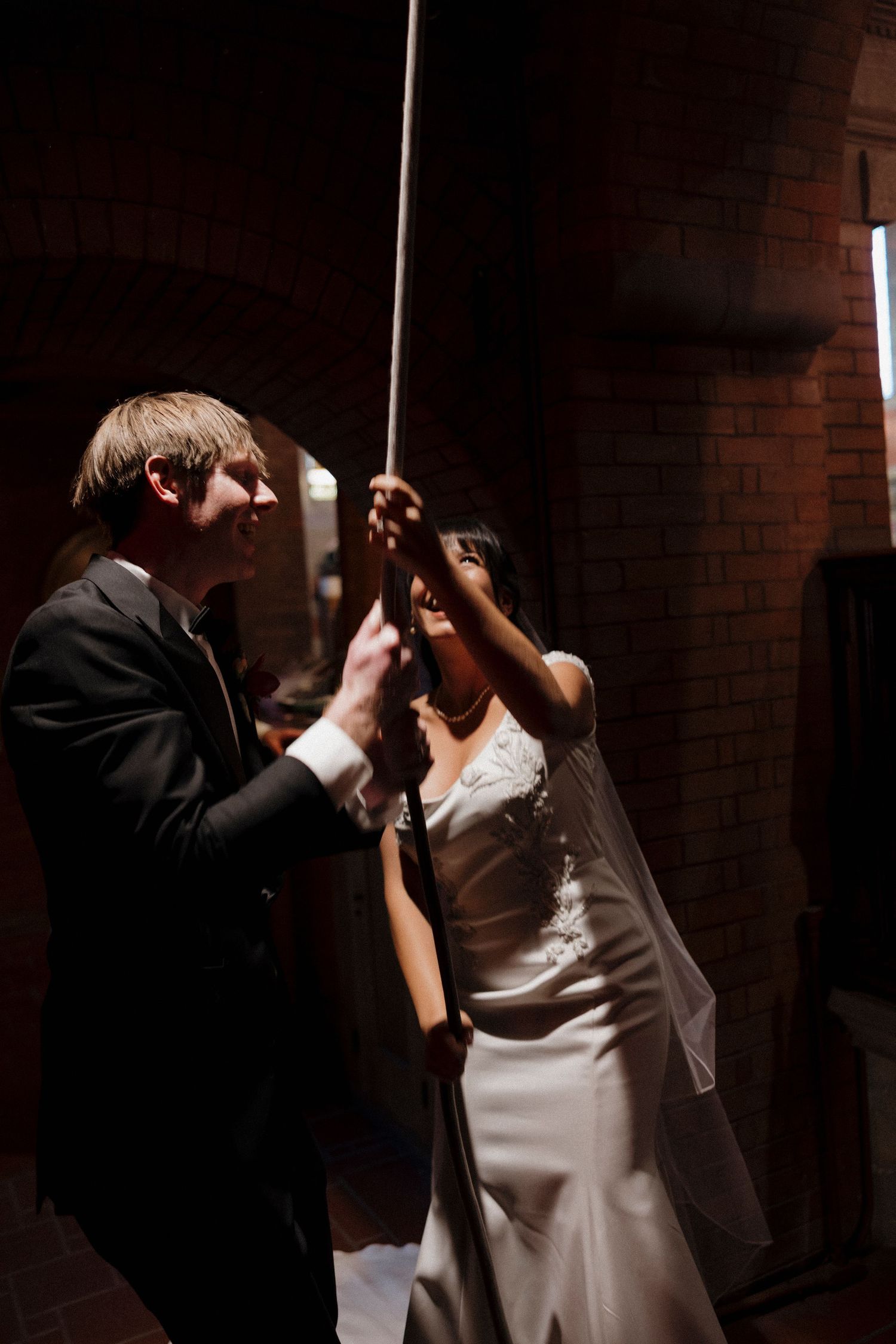 Couple shares an intimate dance moment in dark atmospheric lighting.