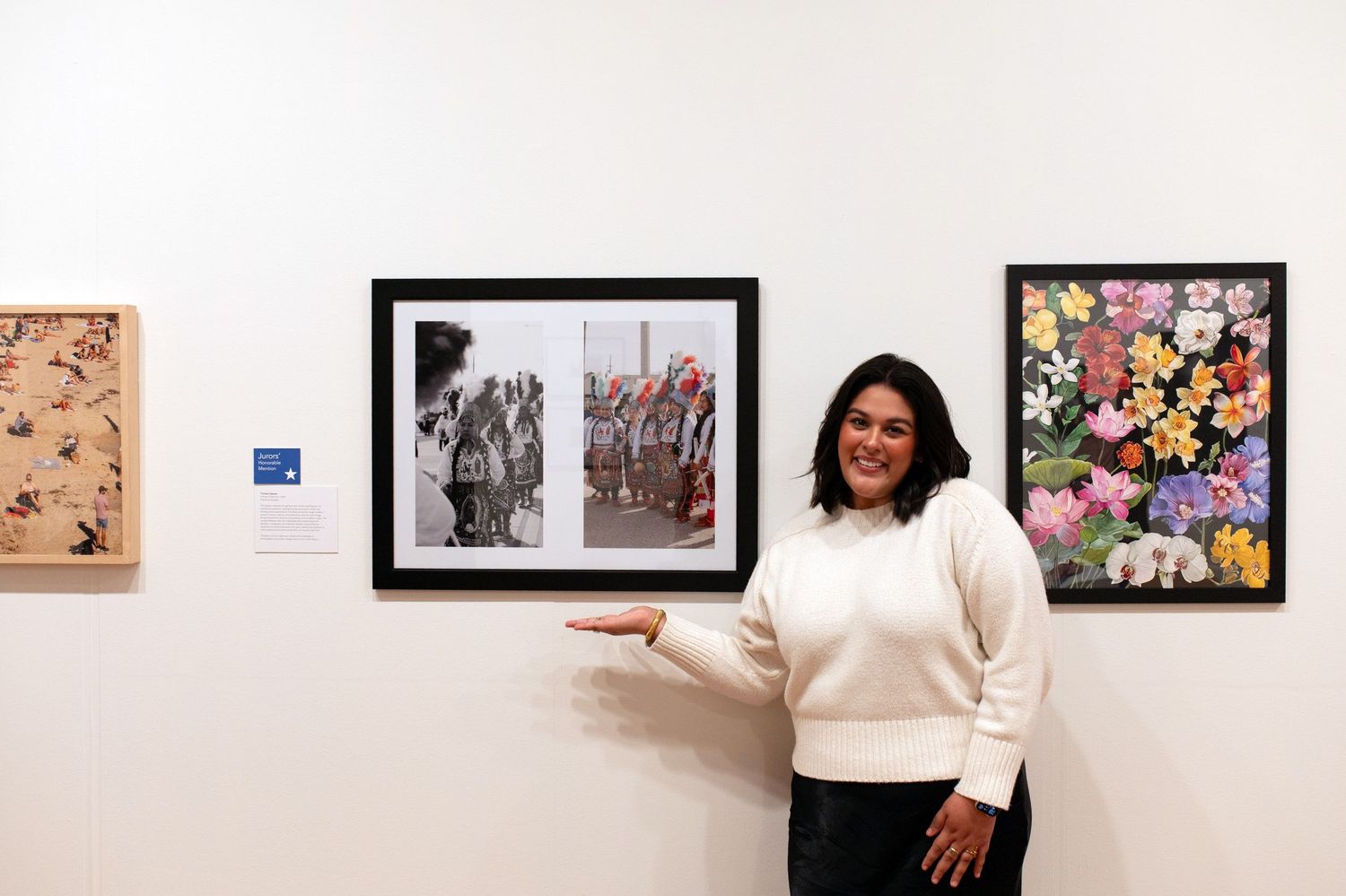 Art gallery wall displaying framed photographs and floral artwork.