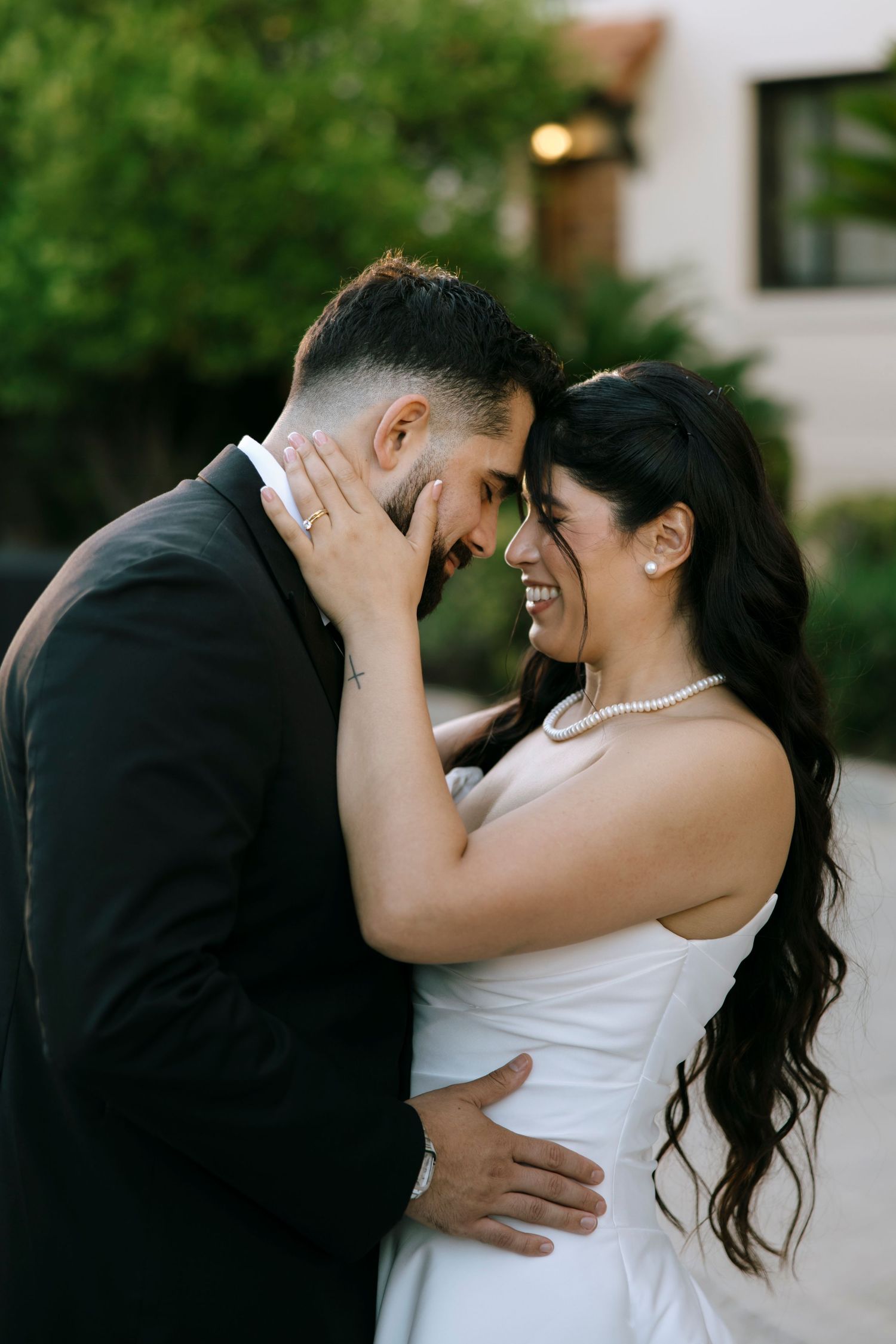 Intimate wedding couple portraits captured in warm evening light outdoors.