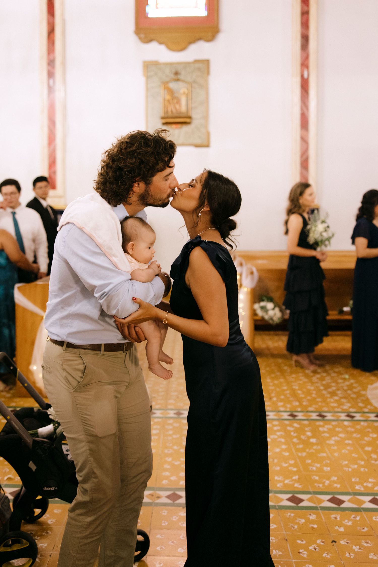 Couples dancing together during a celebration in a church hall.