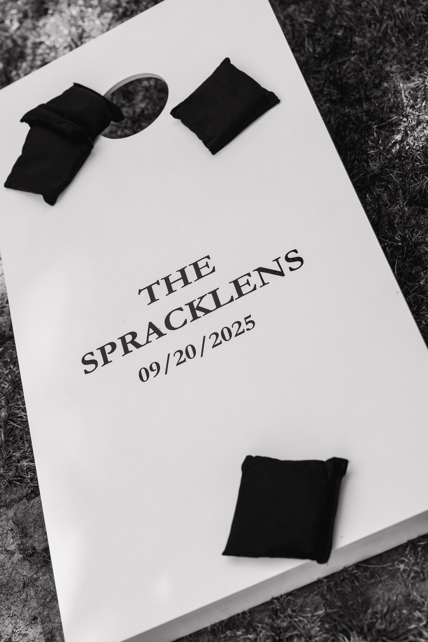 Black and white close-up of paper wedding signage with dark decorative elements.