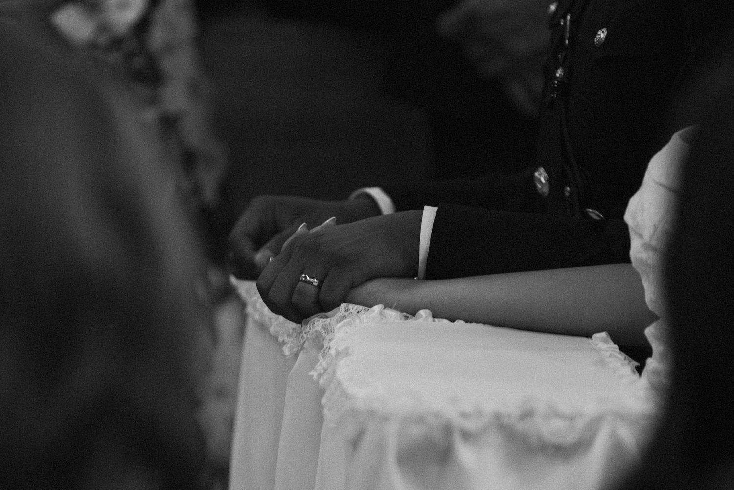 Dark artistic close-up shot of a wedding ceremony detail.