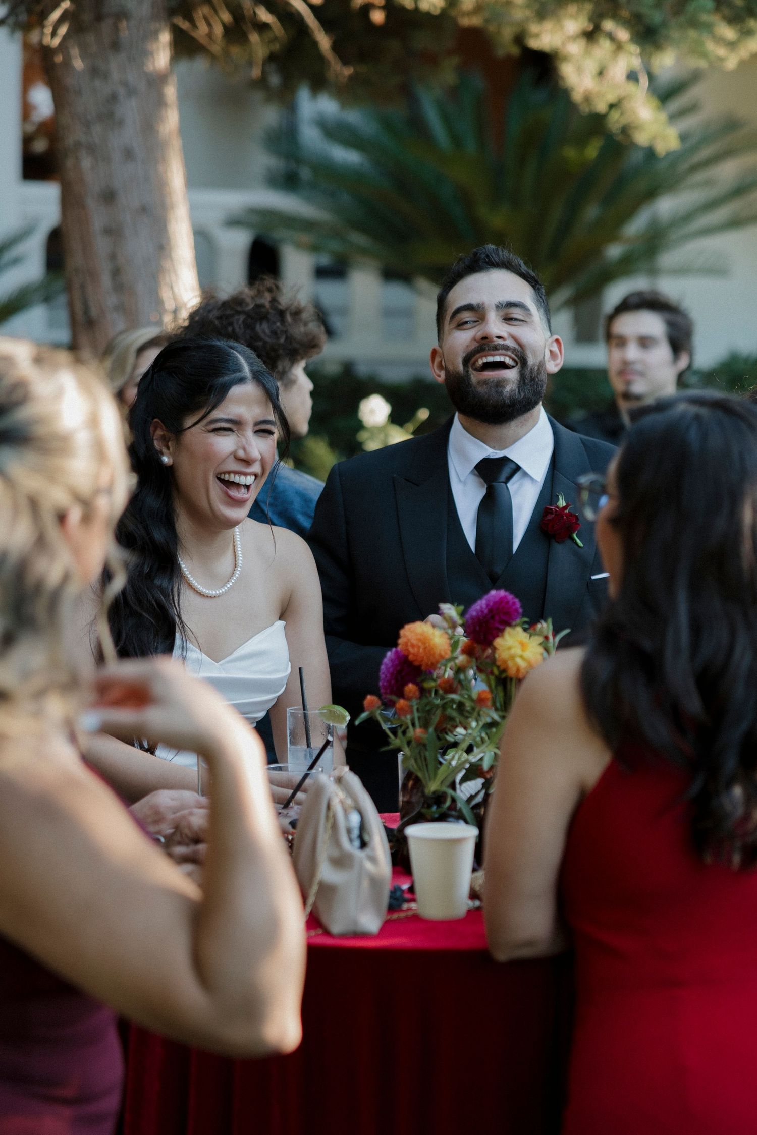 Candid moments of laughter and joy during an outdoor wedding celebration.