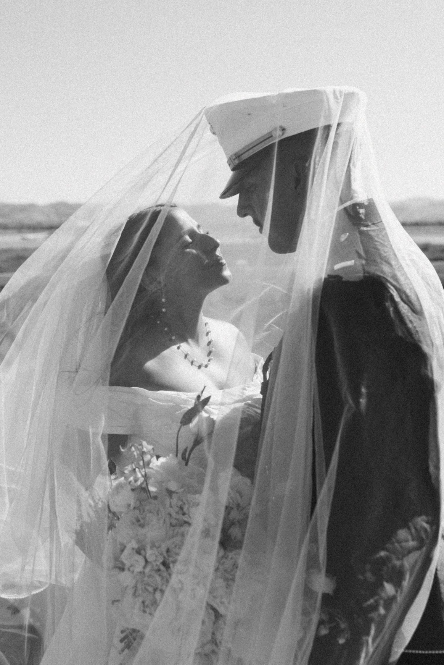 Artistic black and white wedding veil silhouettes creating romantic profile shots.