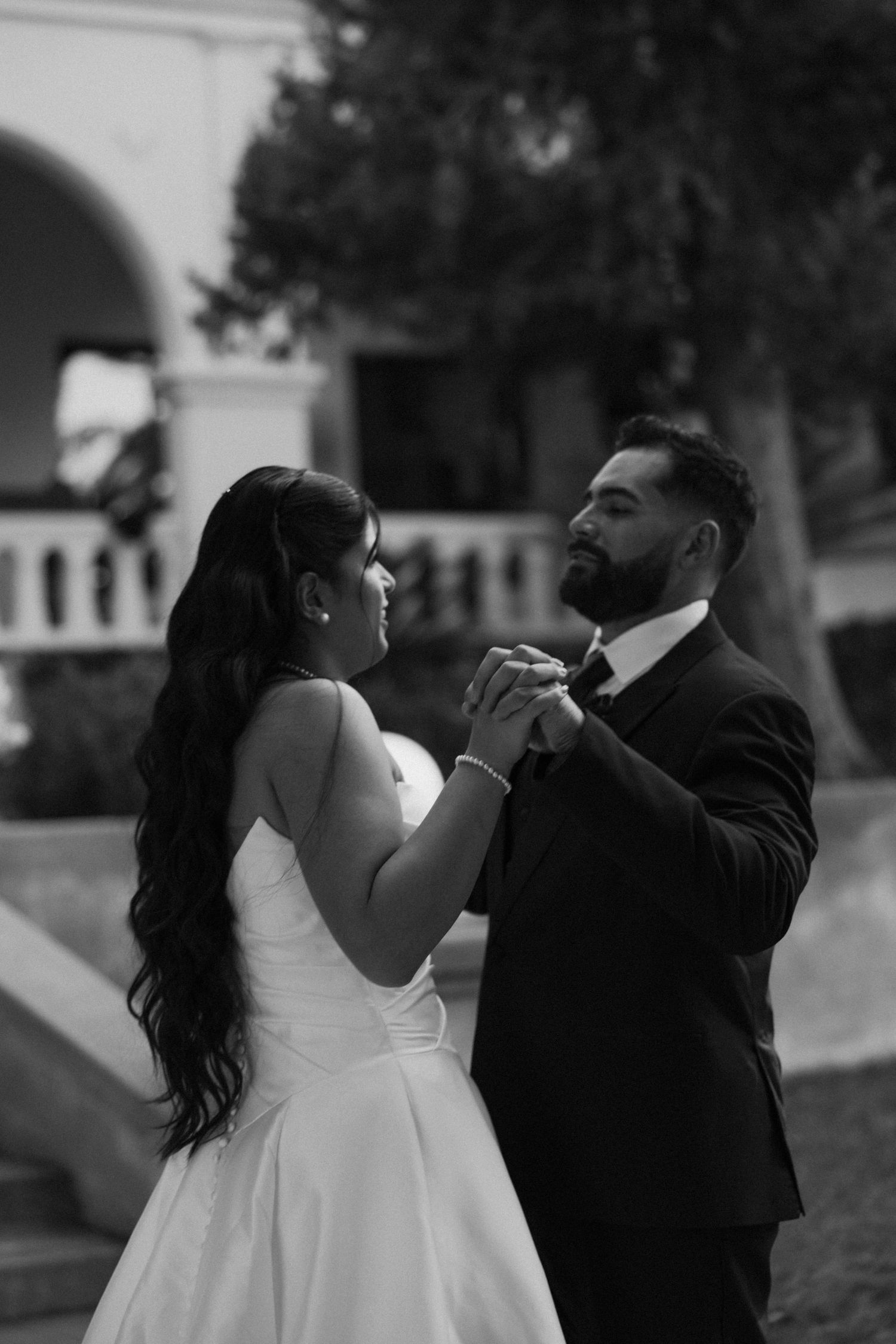 Romantic outdoor wedding moment captured in black and white.