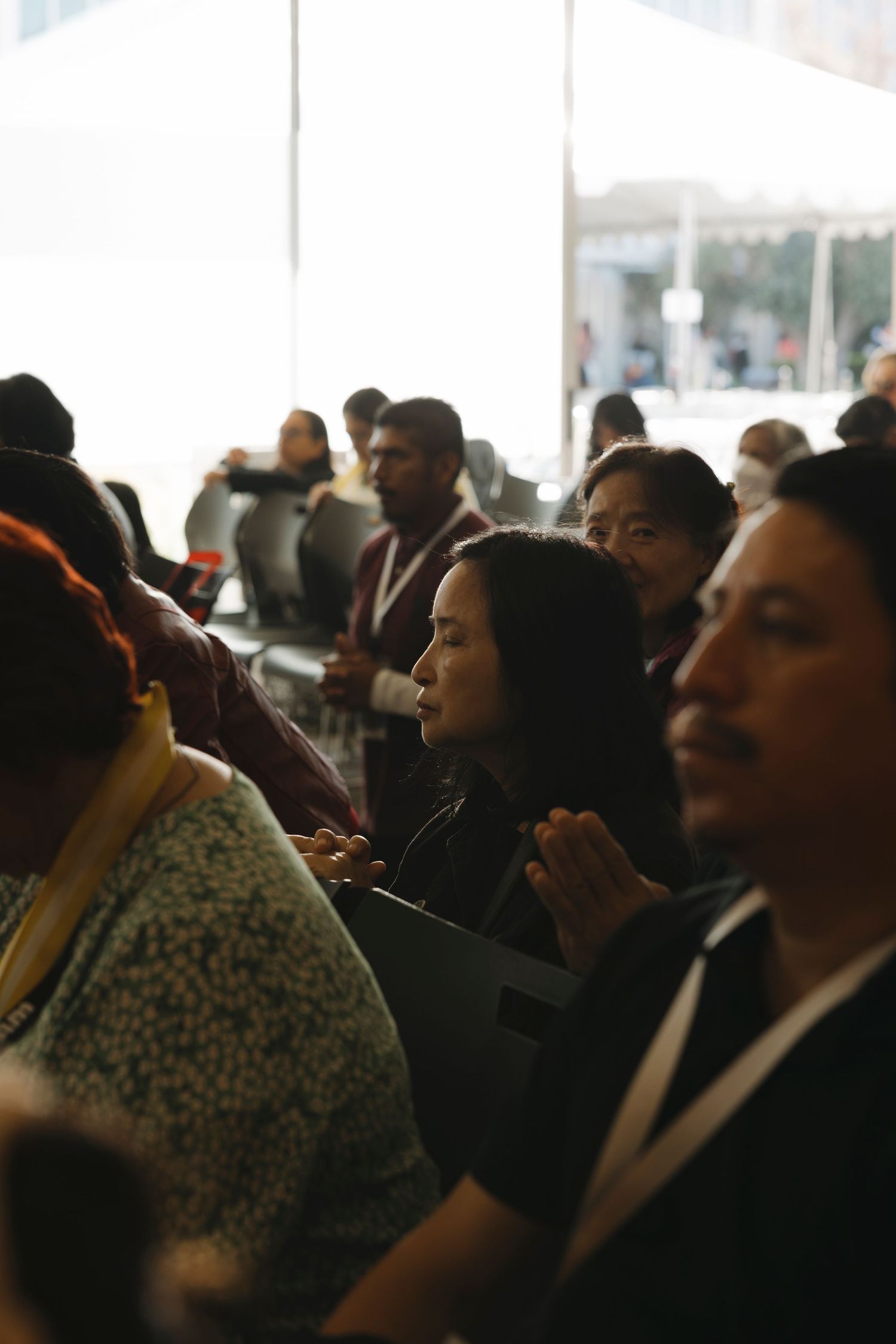 Audience members seated in rows at an indoor gathering.