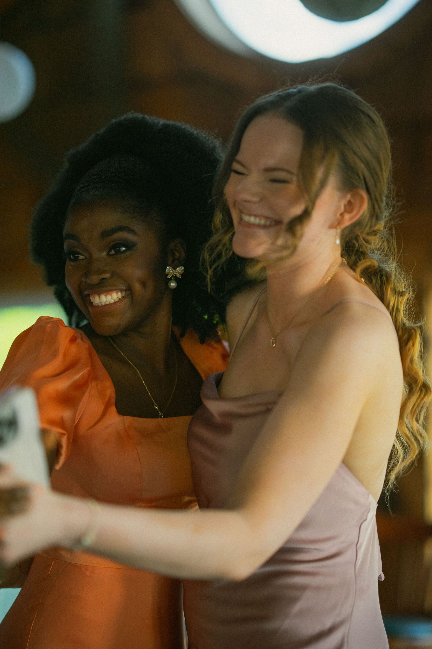 Two people share joyful embraces and laughter in a series of candid moments.