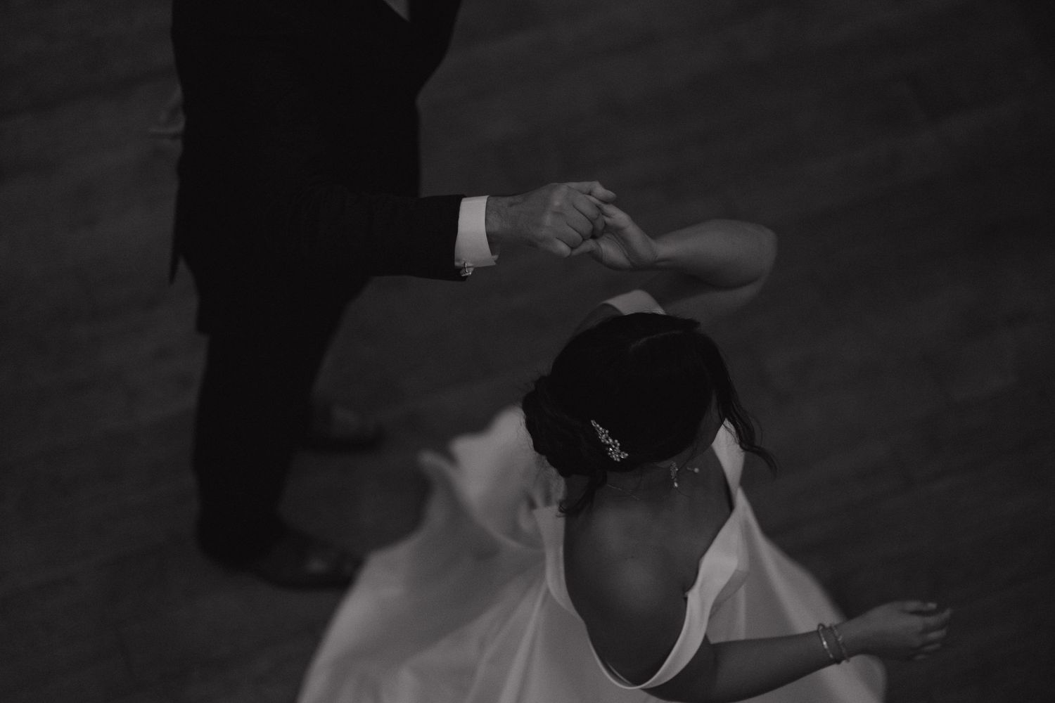Newly married couple spinning around on the dance floor during their wedding reception at Herrington on the Bay in North Beach, Maryland