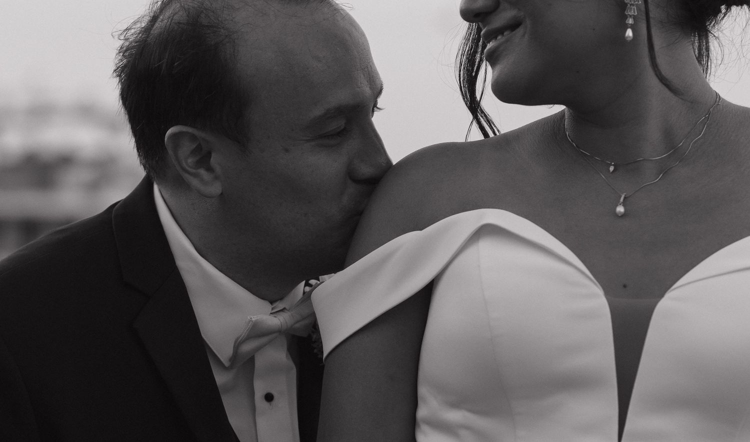 A romantic black and white photo collage showing intimate moments between a couple on their wedding day.