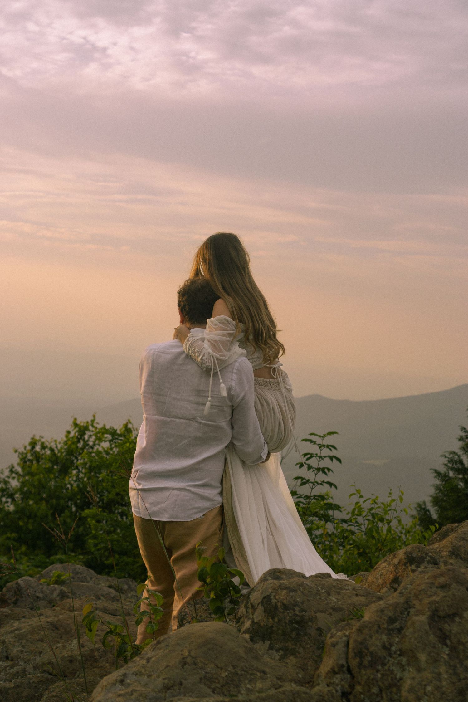 Couple gazing towards the sunset overlooking the Shenandoah Valley