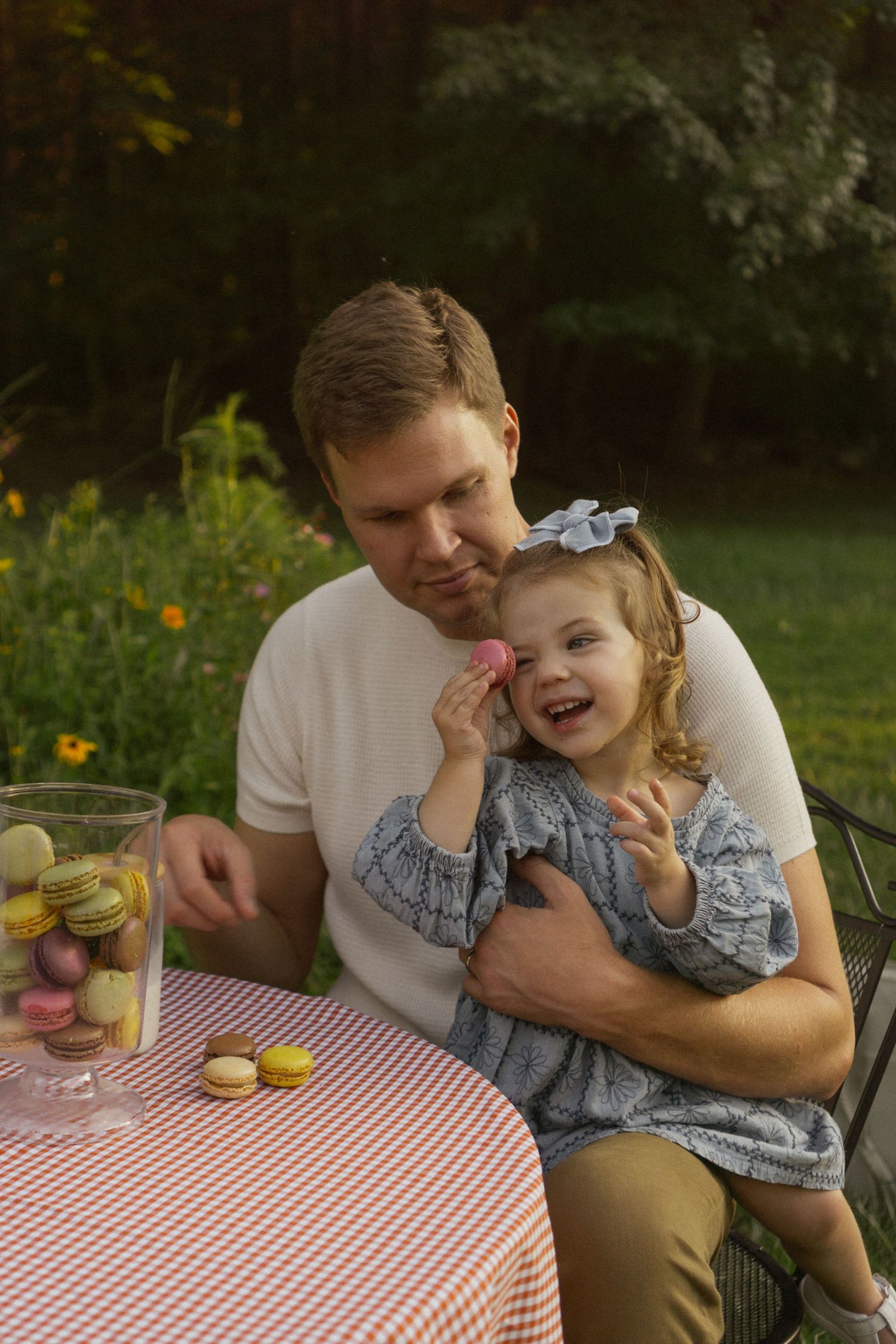 Sweet moment shared at a picnic table with red and white checkered tablecloth.