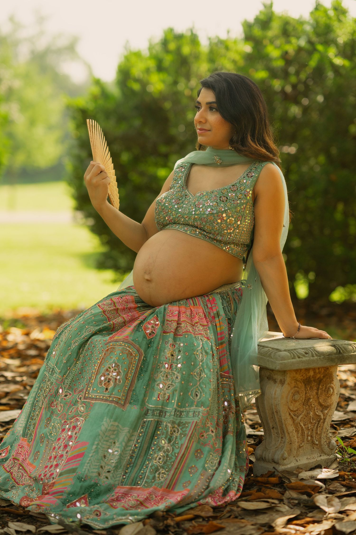 Maternity photoshoot in a garden setting featuring a sparkly mint green and pink lehenga. Morven Park, Leesburg, Virginia.