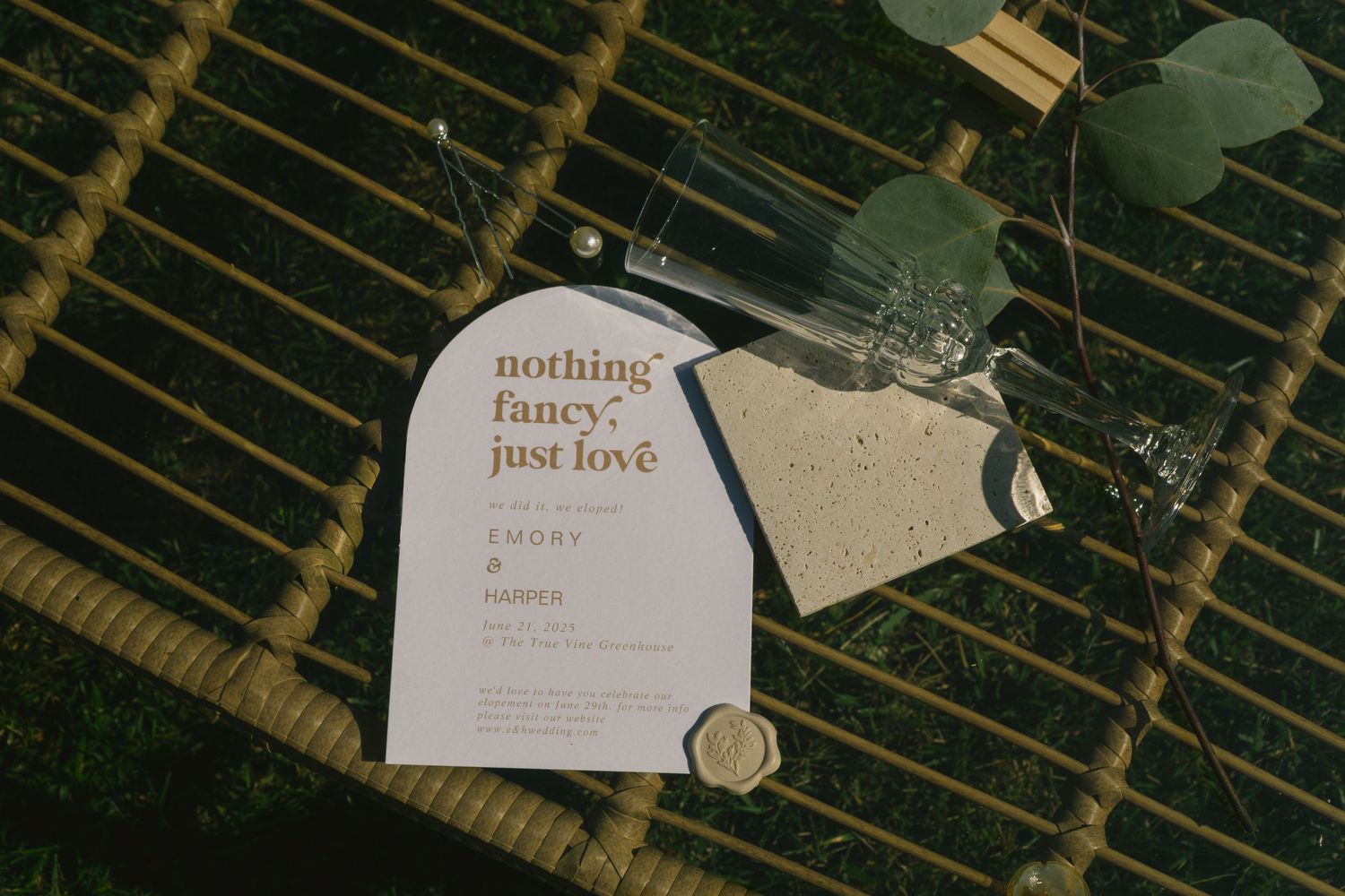 Simple wedding invitation with gold text reading 'nothing fancy just love' on natural background.