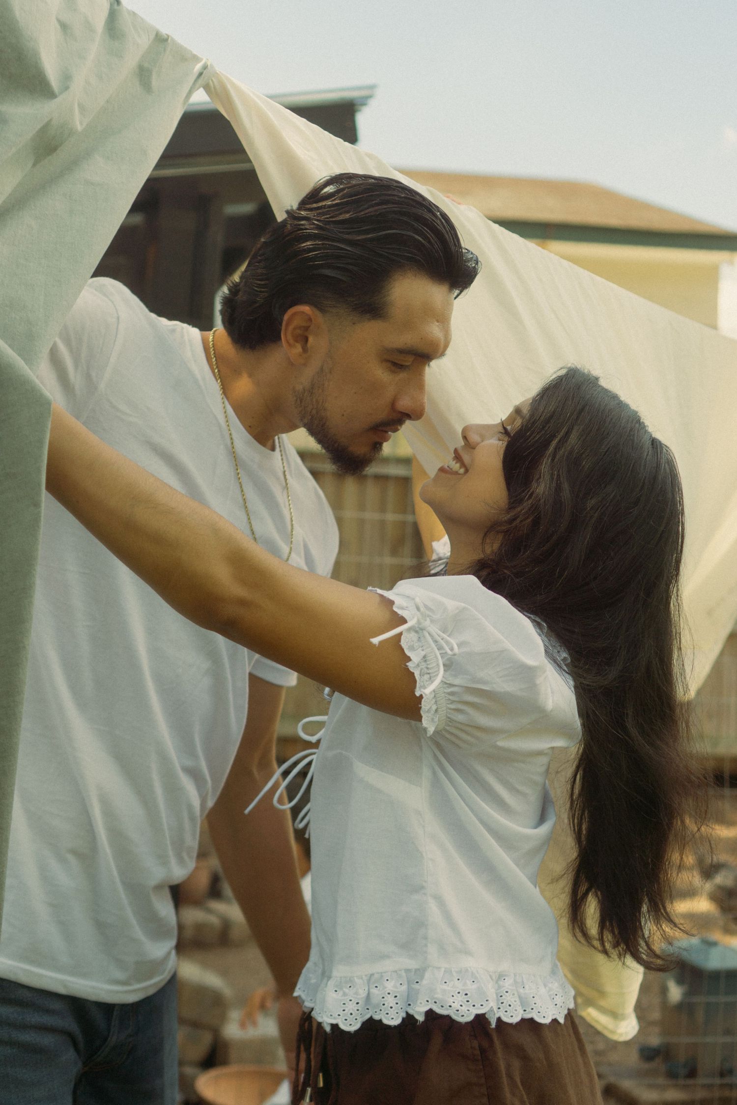 A romantic dance sequence shows a couple in an intimate embrace against a soft, dreamy background.