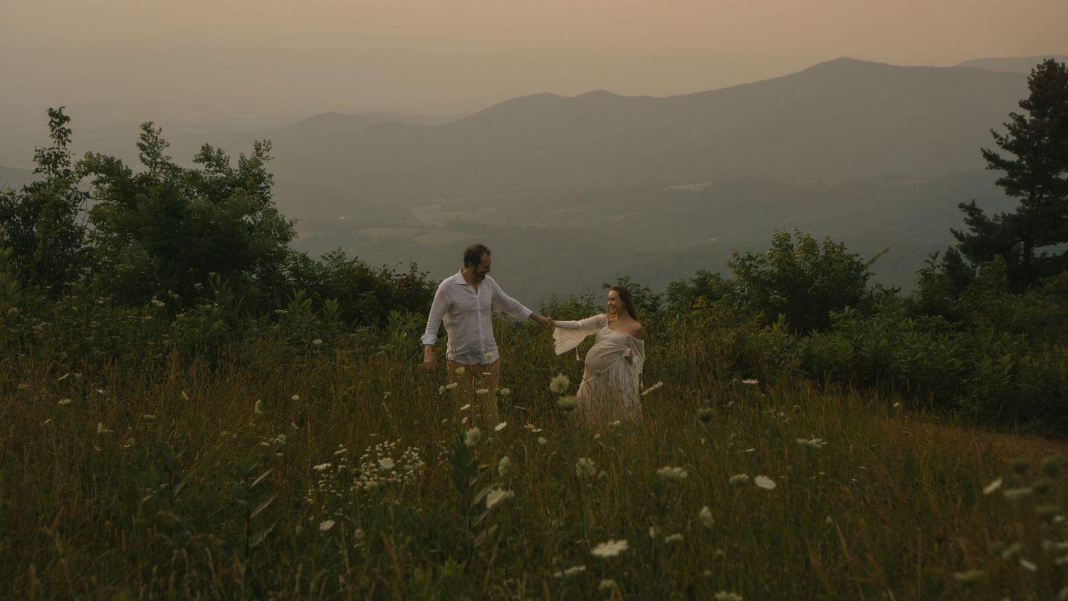 Panoramic sunset view of rolling mountains with silhouettes against a dusky sky. Shenandoah Mountains