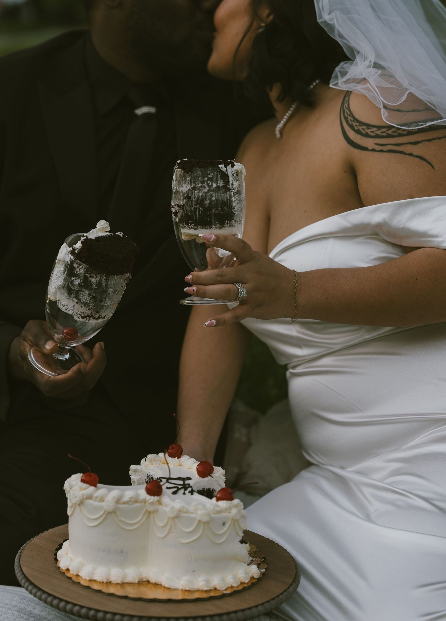 Wedding cake and champagne glasses being shared in an intimate outdoor setting.