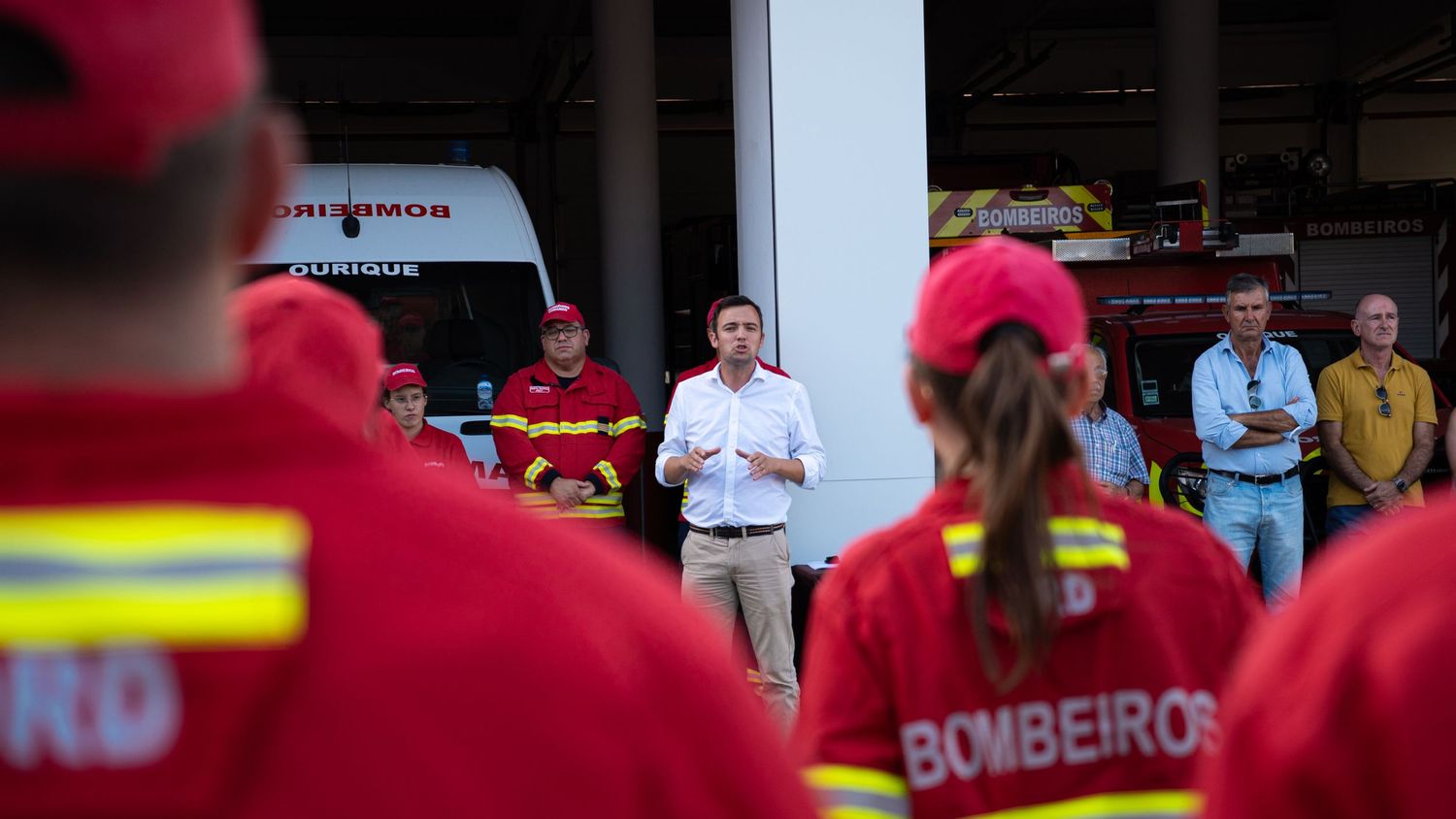 Emergency response team members in red uniforms gathered for training.