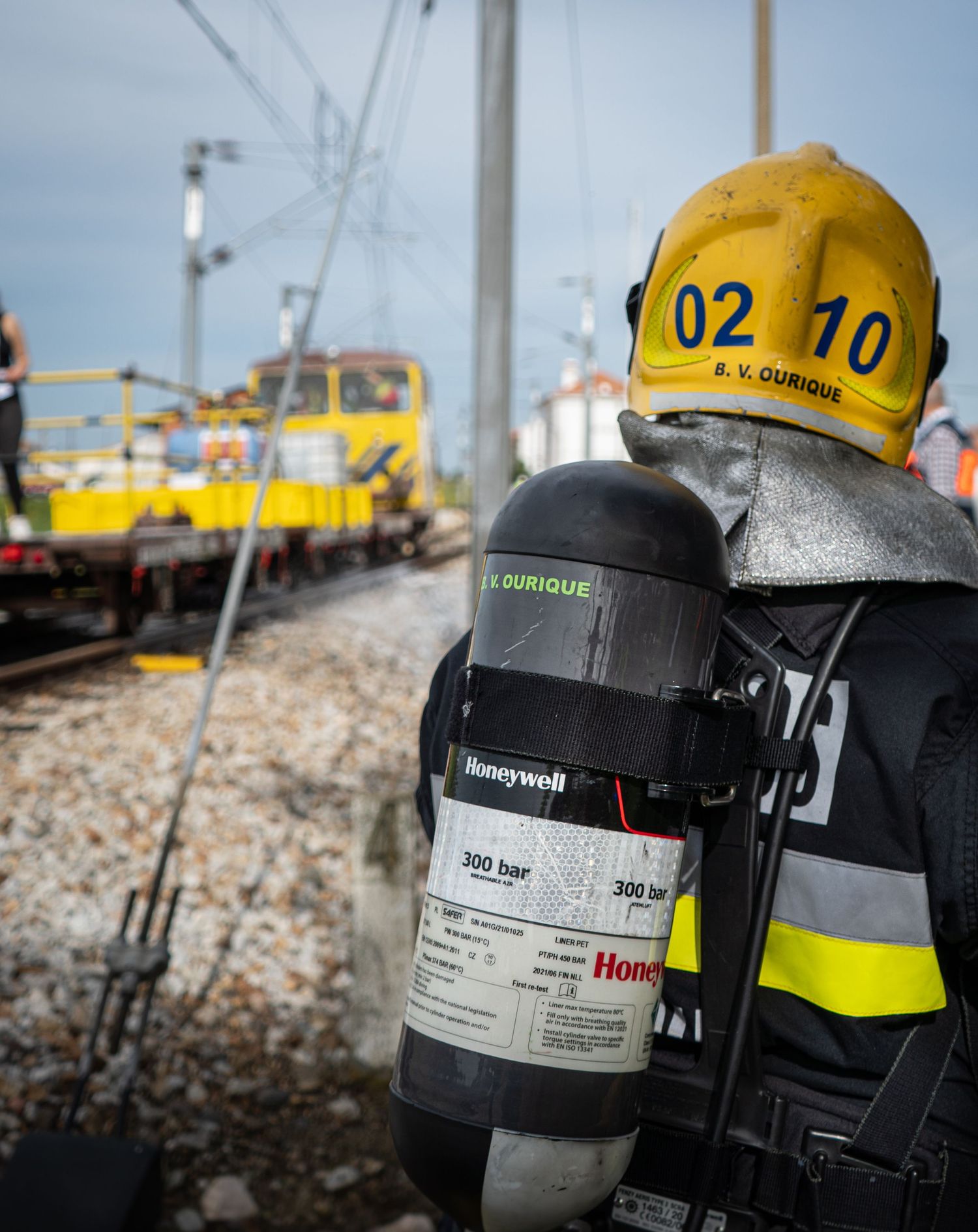 Close-up view of firefighter oxygen tanks and breathing equipment arranged in a row.