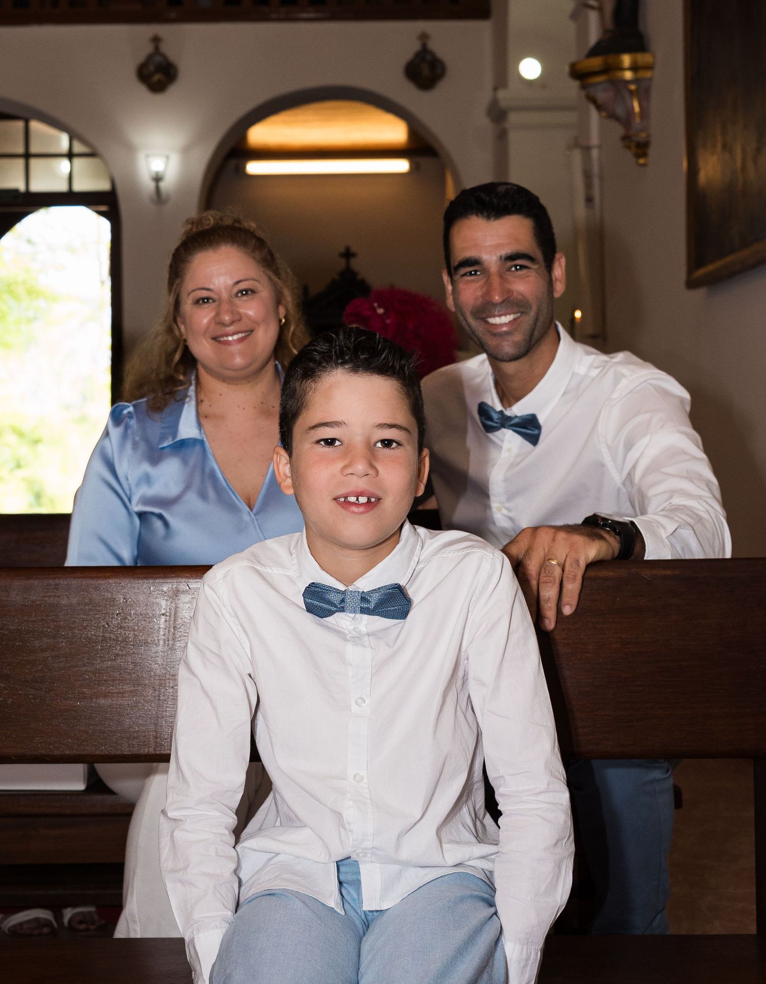 Indoor family photos showing casual poses and blue bow tie accents.