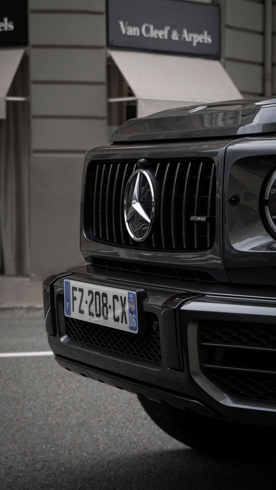 Close-up shots of a black Mercedes-AMG grille and front bumper details.